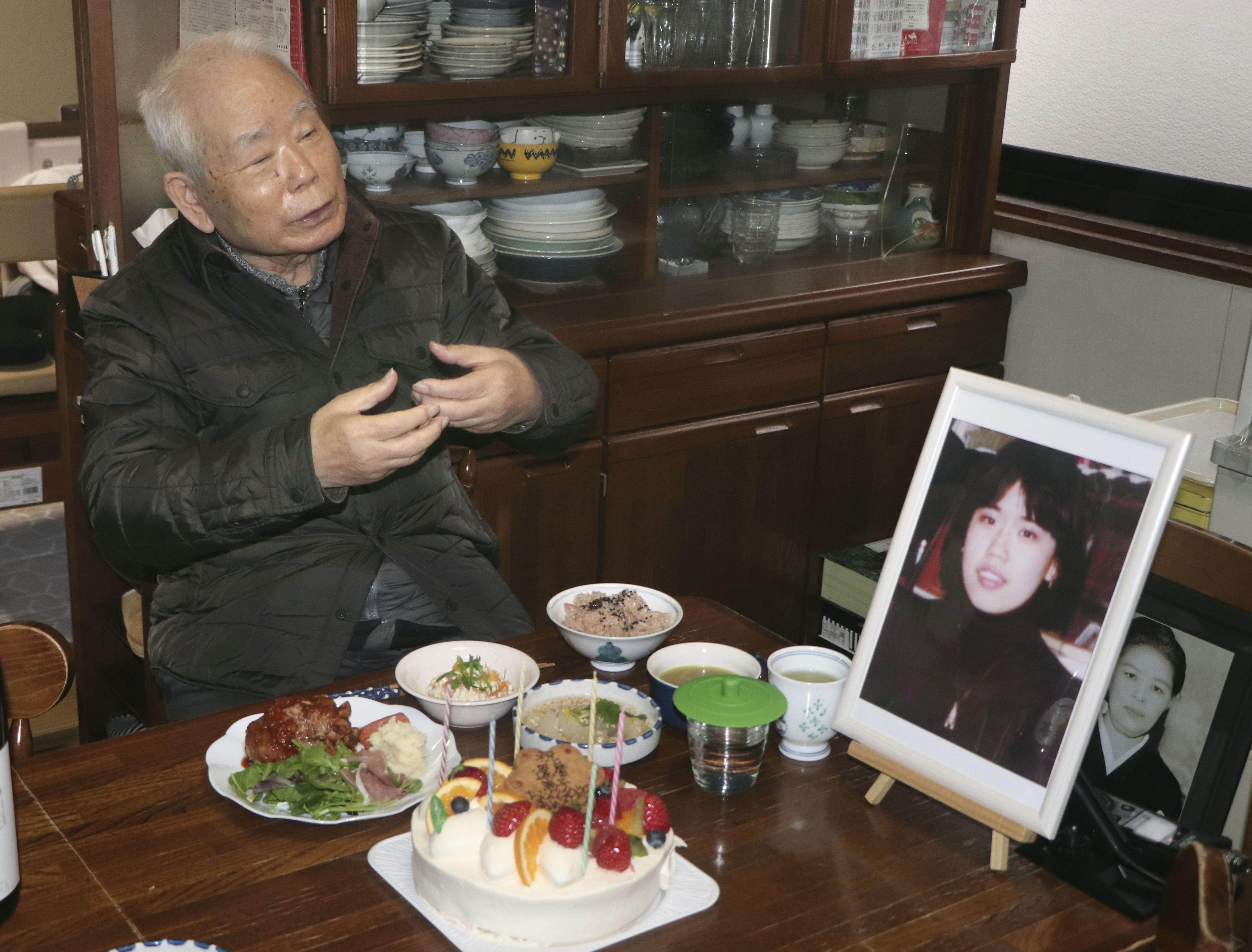 Akihiro Arimoto, whose daughter Keiko was taken to North Korea in 1983 at age 23, pictured in 2020 with her photo. Photo: Kyodo