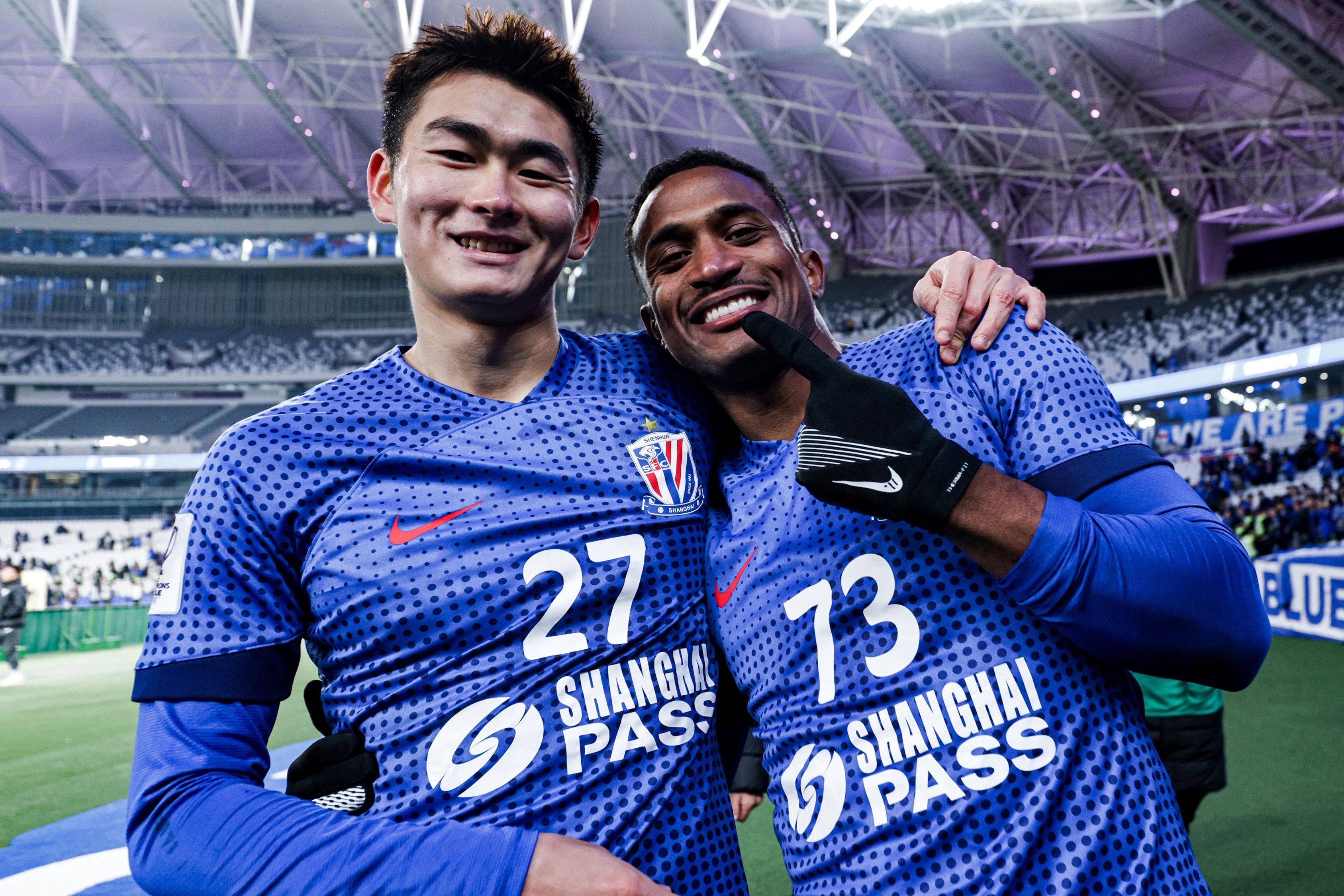 Hong Kong’s Shinichi Chan (left) alongside hat-trick hero Saulo Mineiro  after Shanghai Shenhuas impressive win over Japans Vissel Kobe. Photo: AFP