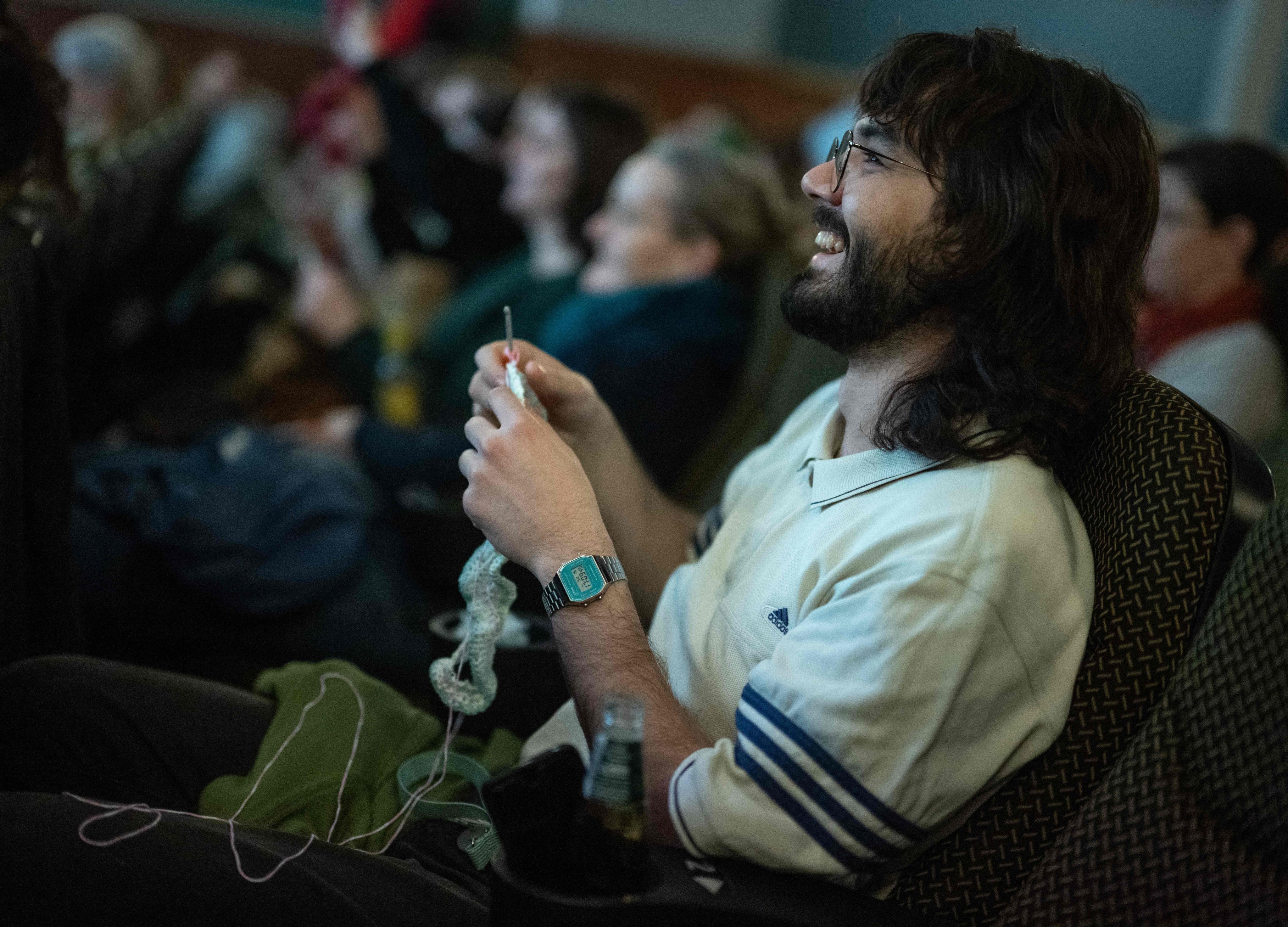 A man knits during a showing of The Devil Wears Prada at the Votive Cinema in Vienna, Austria. These sold-out crafty film showings happen once a month. Photo: AFP