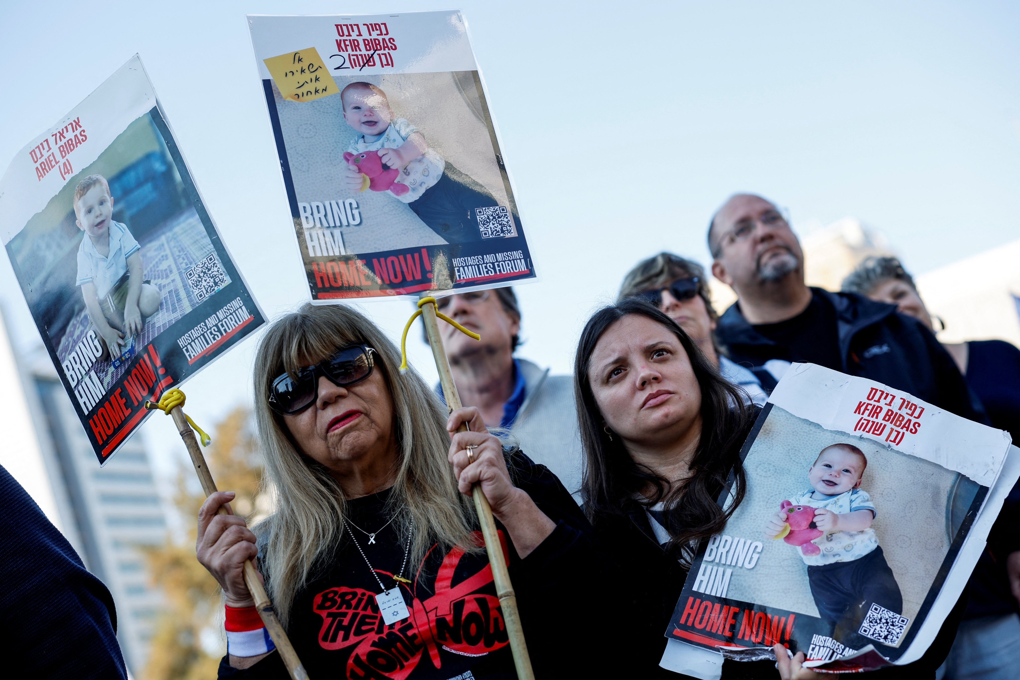 People carry placards with pictures of child hostages Kfir and Ariel Bibas in Tel Aviv, Israel, on February. Photo: Reuters