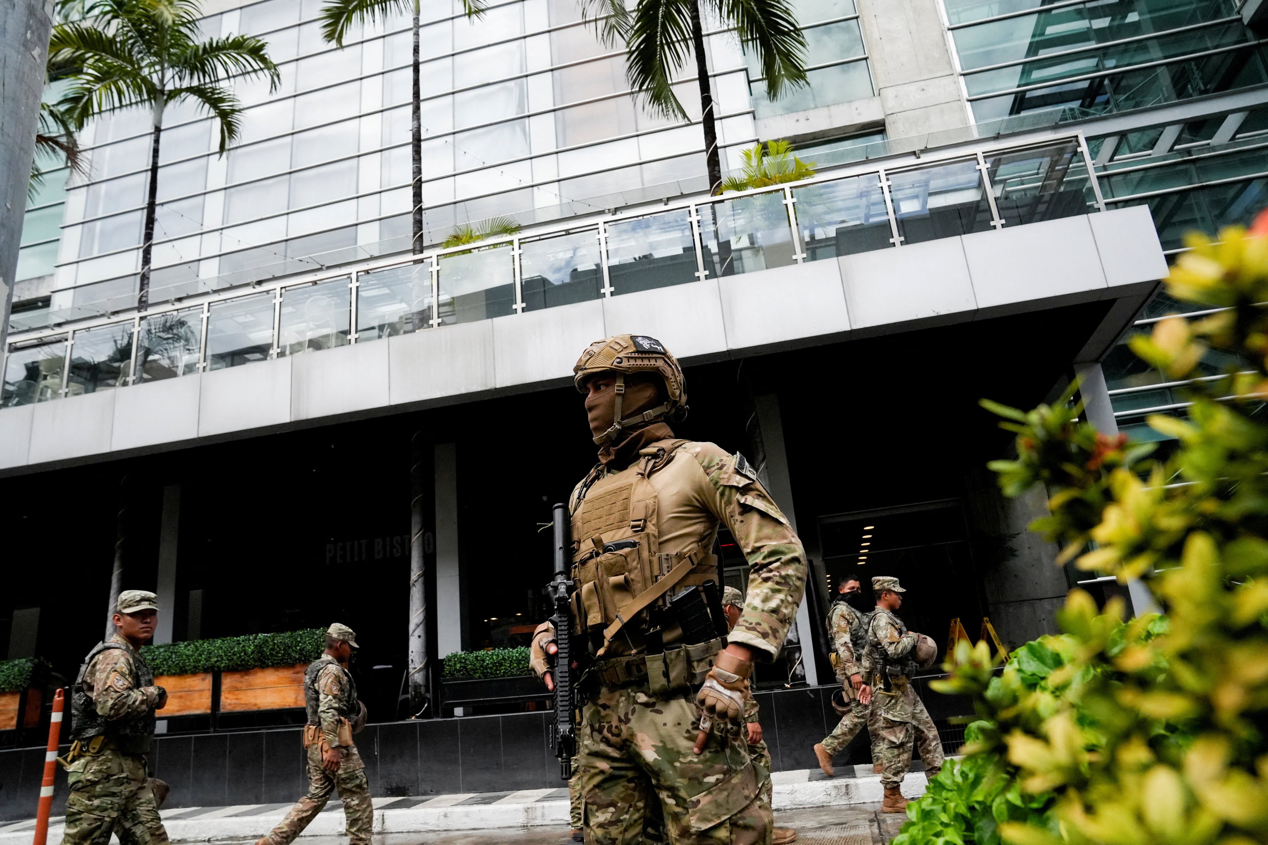 Members of Panama’s National Aeronaval Service police on Tuesday stand outside the hotel where migrants are being housed after being deported to Panama from the US. Photo: Reuters