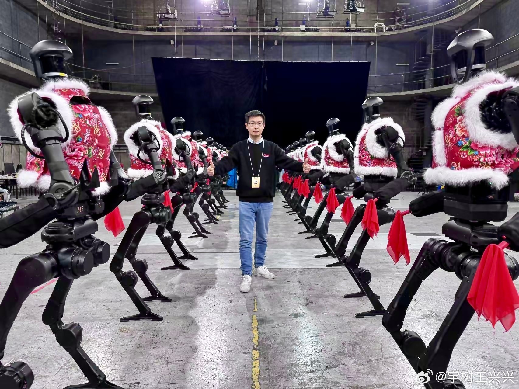 Wang Xingxing, CEO of Unitree Robotics, posing with the company’s humanoid robots. Photo: Weibo