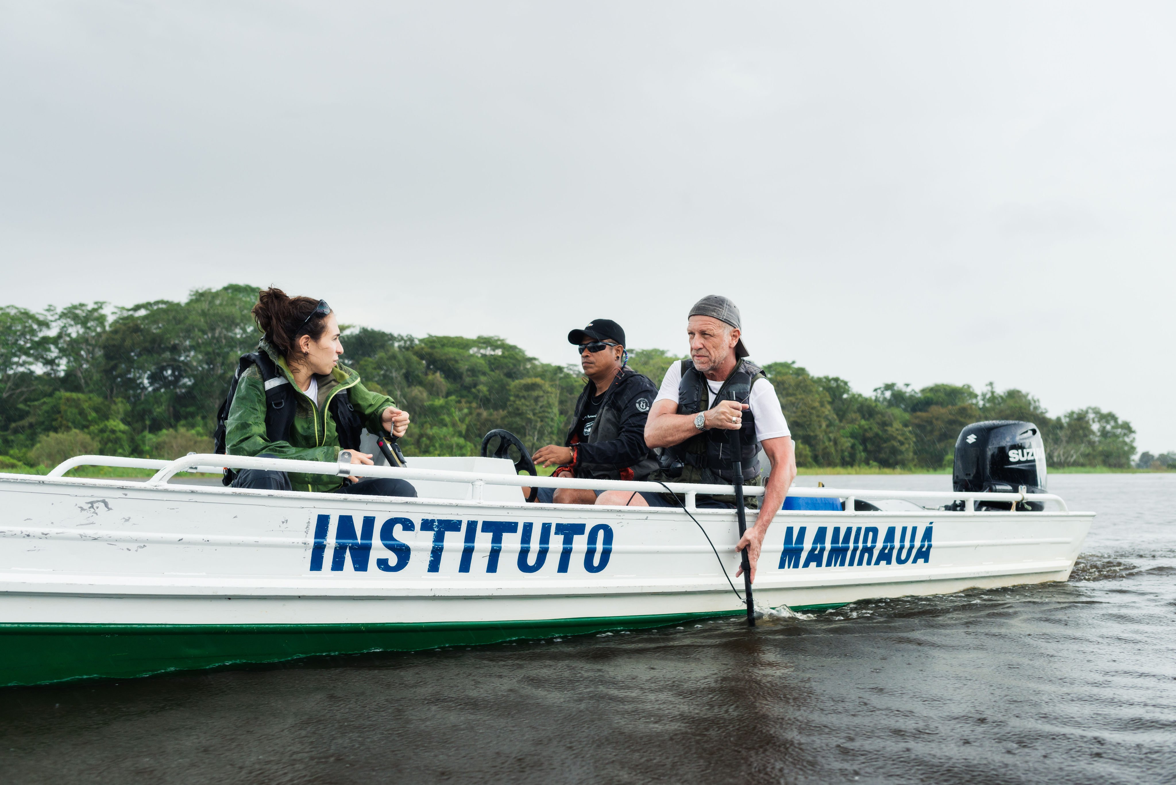 Michel André (far right) deploys a hydrophone into a river with his team to record underwater sounds for research at Brazil’s Mamirauá Sustainable Development Reserve. Photo: Rolex/Diego Bresani