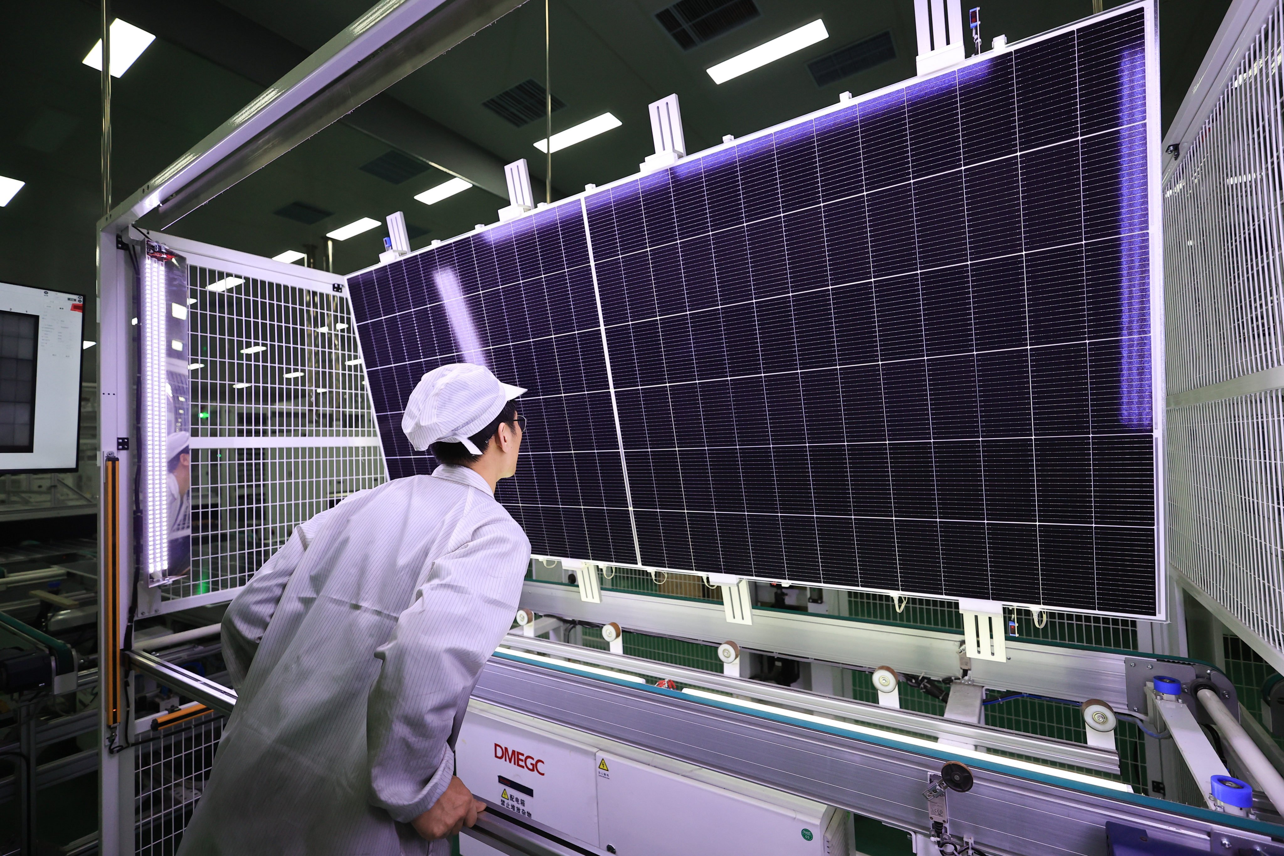 An employee inspects a solar panel at a workshop of a photovoltaic enterprise on December 25, 2024 in Lianyungang in China’s Jiangsu province. Photo: VCG via Getty Images