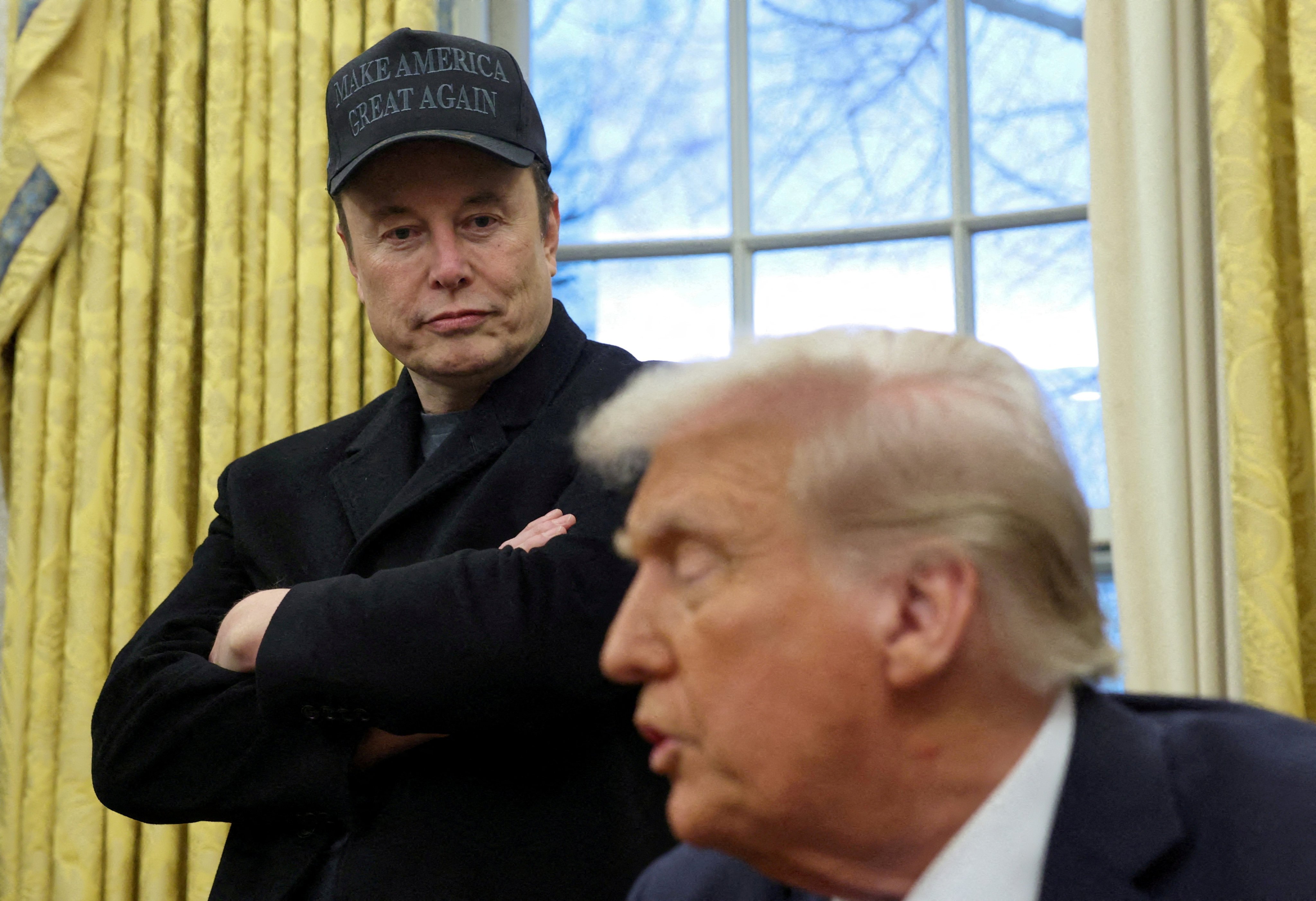 Elon Musk listens to US President Donald Trump speak in the White House on February 11, 2025. Photo: Reuters