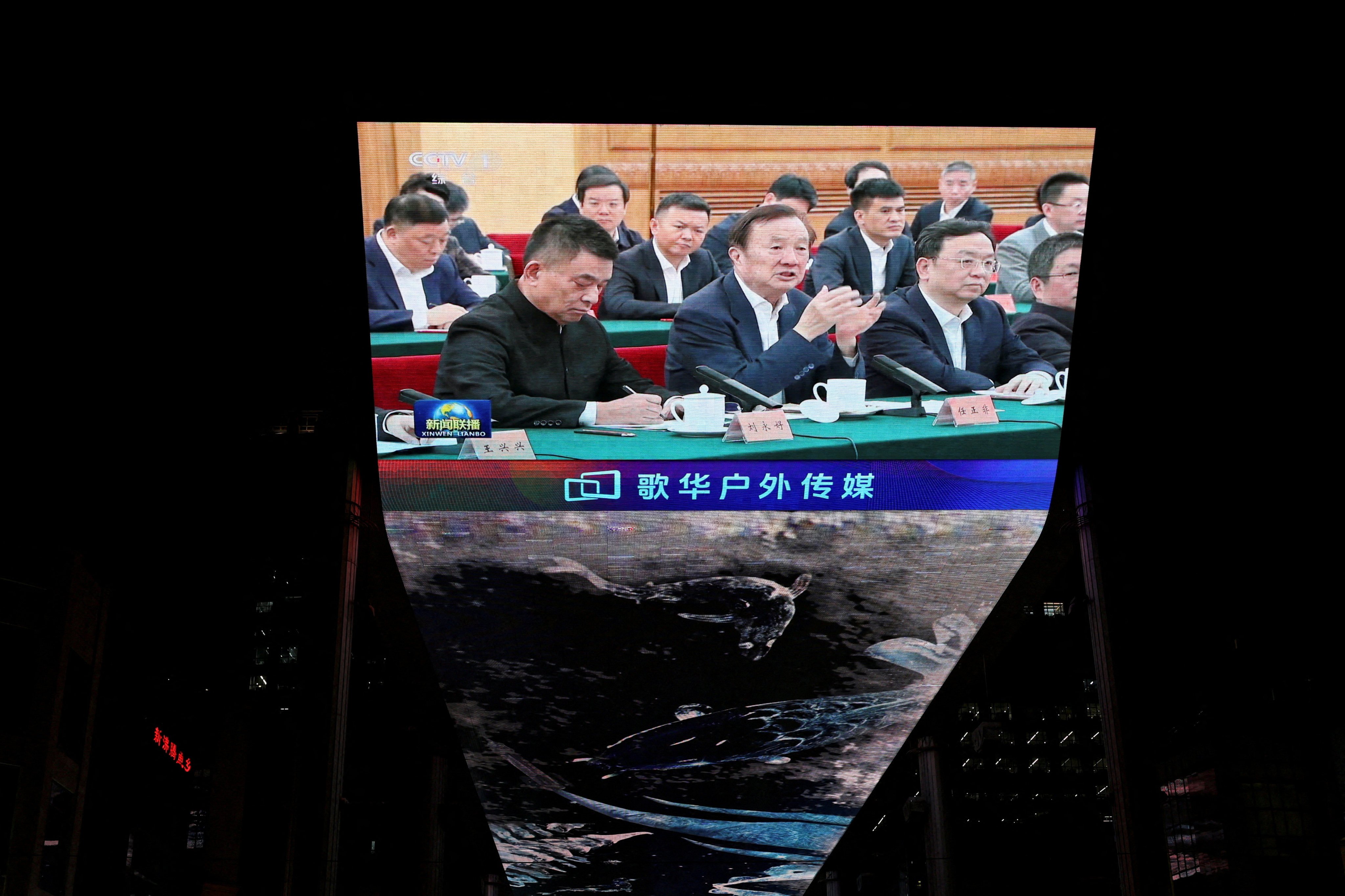 A giant screen at a Beijing shopping centre shows news footage of Huawei founder Ren Zhengfei speaking next to BYD CEO Wang Chuanfu and New Hope’s founder and chairman Liu Yonghao at a symposium with Chinese President Xi Jinping on Monday. Photo: Reuters