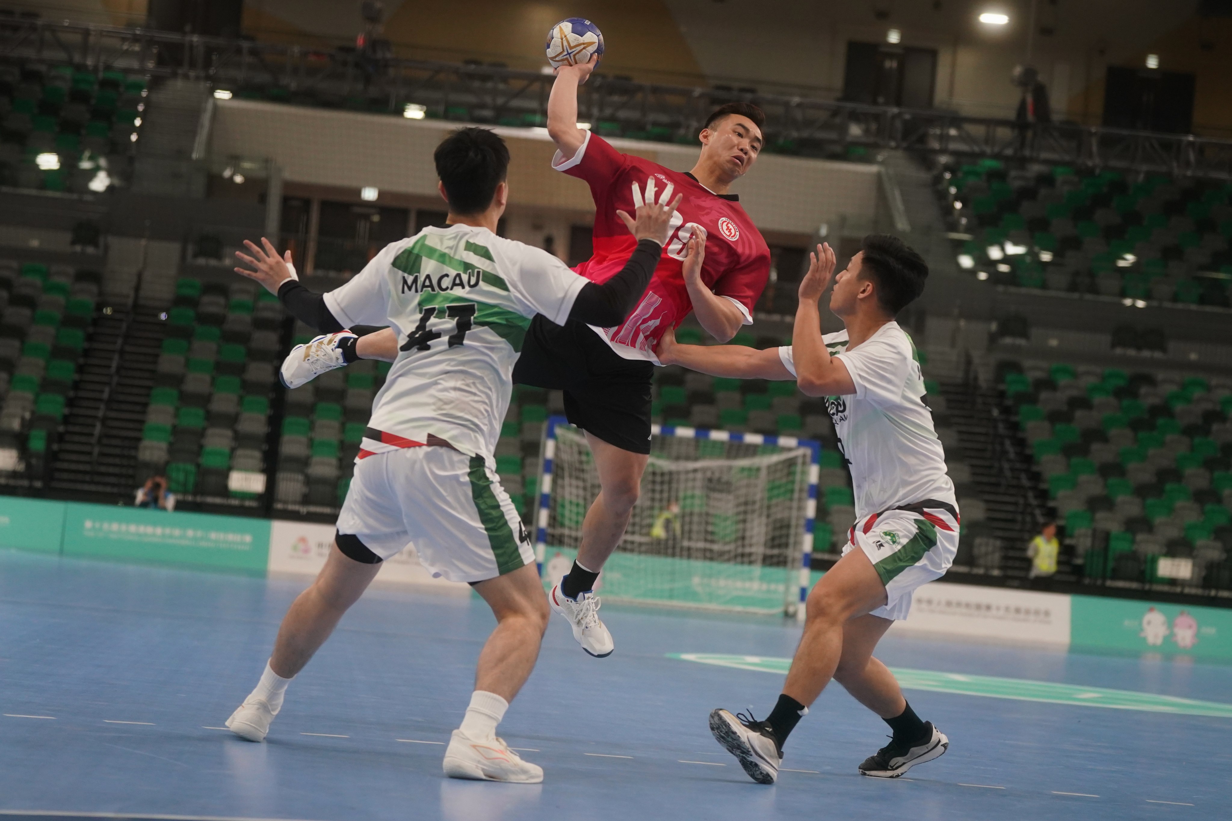 Hong Kong’s  Lin Yun To Toby (centre) scores during the National Games Men Handball Test Event at Kai Tak Arena. Photo: Elson Li