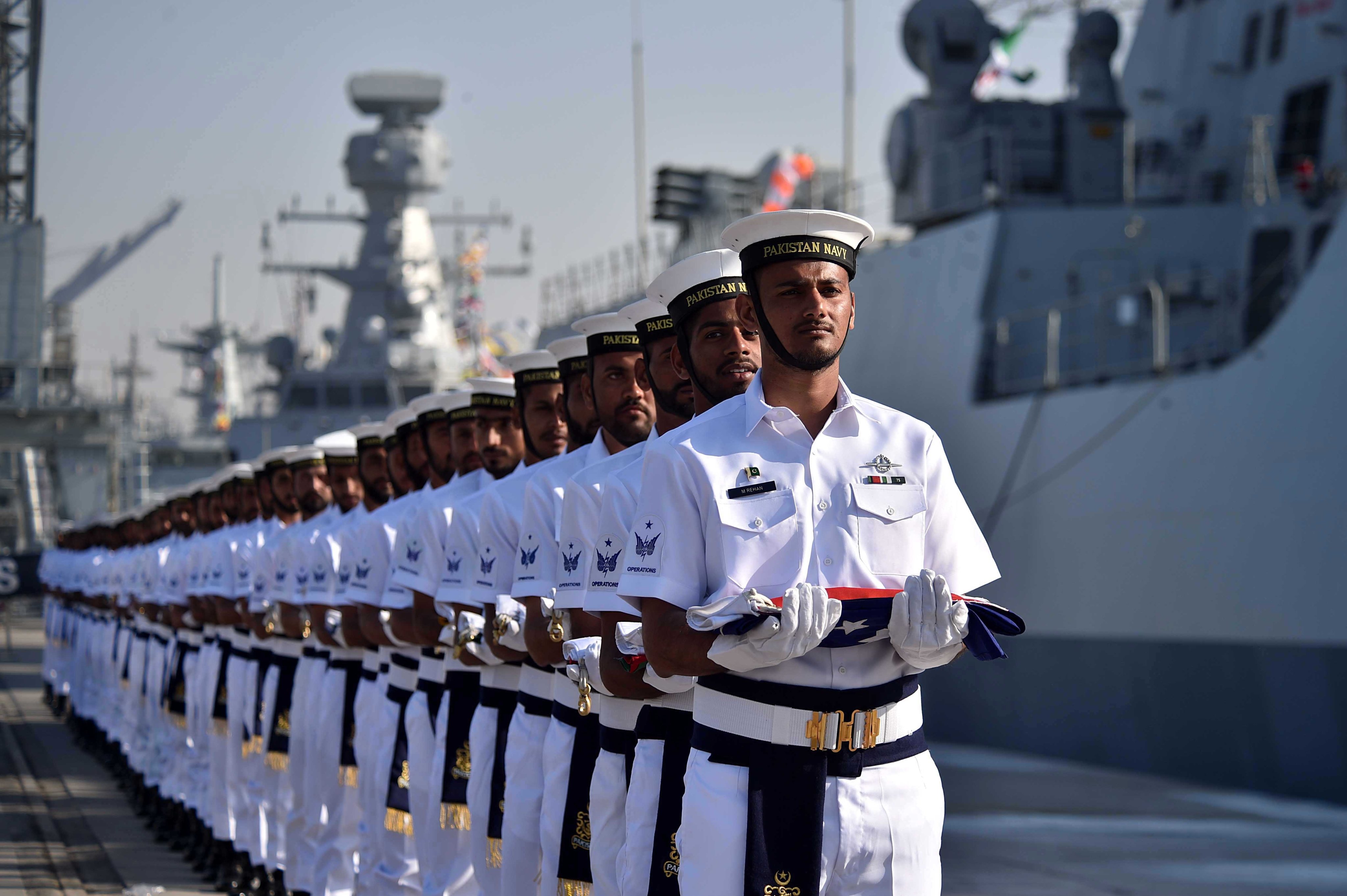 Pakistani navy soldiers carry the national flags of participating countries at the opening ceremony of the Aman multinational exercise, in Karachi, Pakistan, on February 7. The naval exercise, which ran to February 11, was joined by 60 countries including China. Photo: EPA-EFE