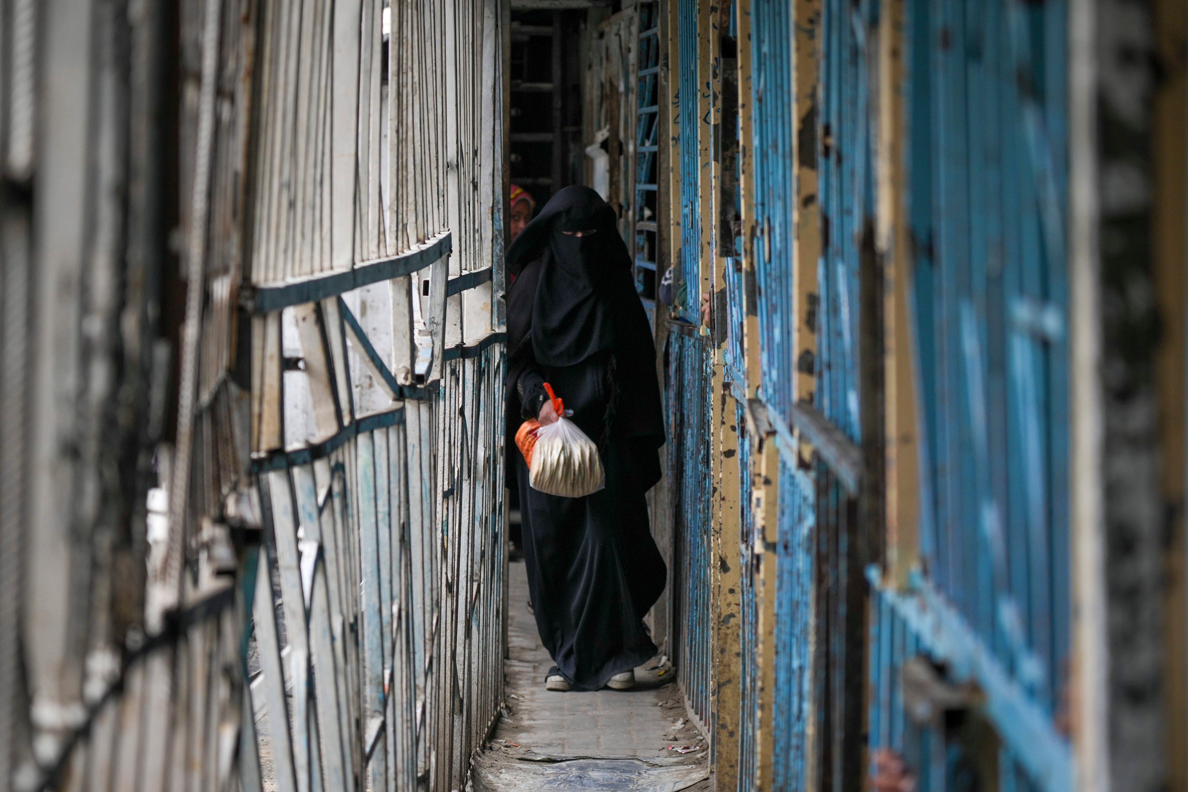 A Palestinian woman walks out of a bakery in Gaza City on Monday. Photo: AP