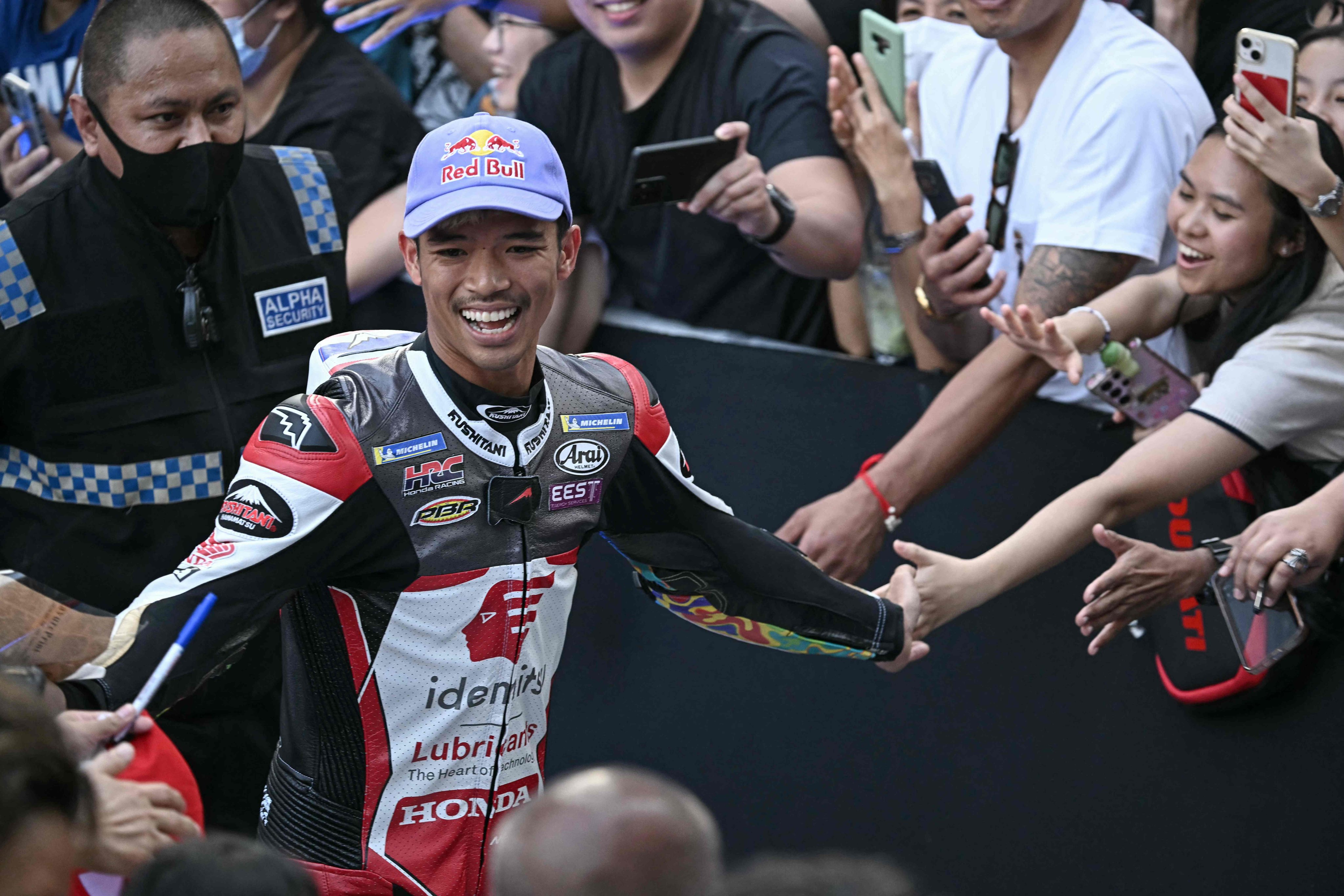 Thai rider Somkiat Chantra greets supporters during the MotoGP launch party at One Bangkok mall in Bangkok on February 9, 2025. Photo: AFP