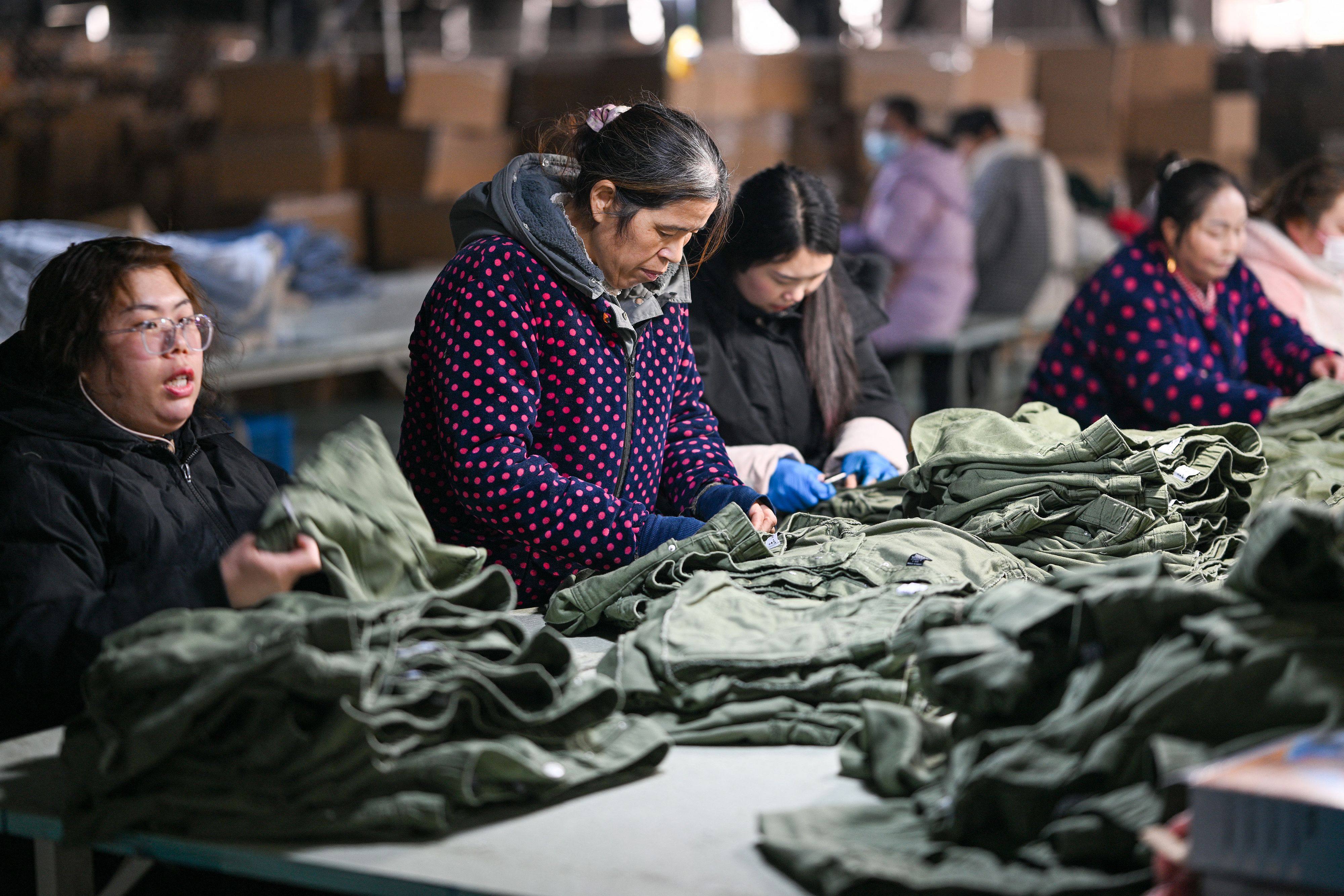 Employees produce clothing for export to Europe and the US, in Suqian, Jiangsu province, on January 23. Photo: AFP