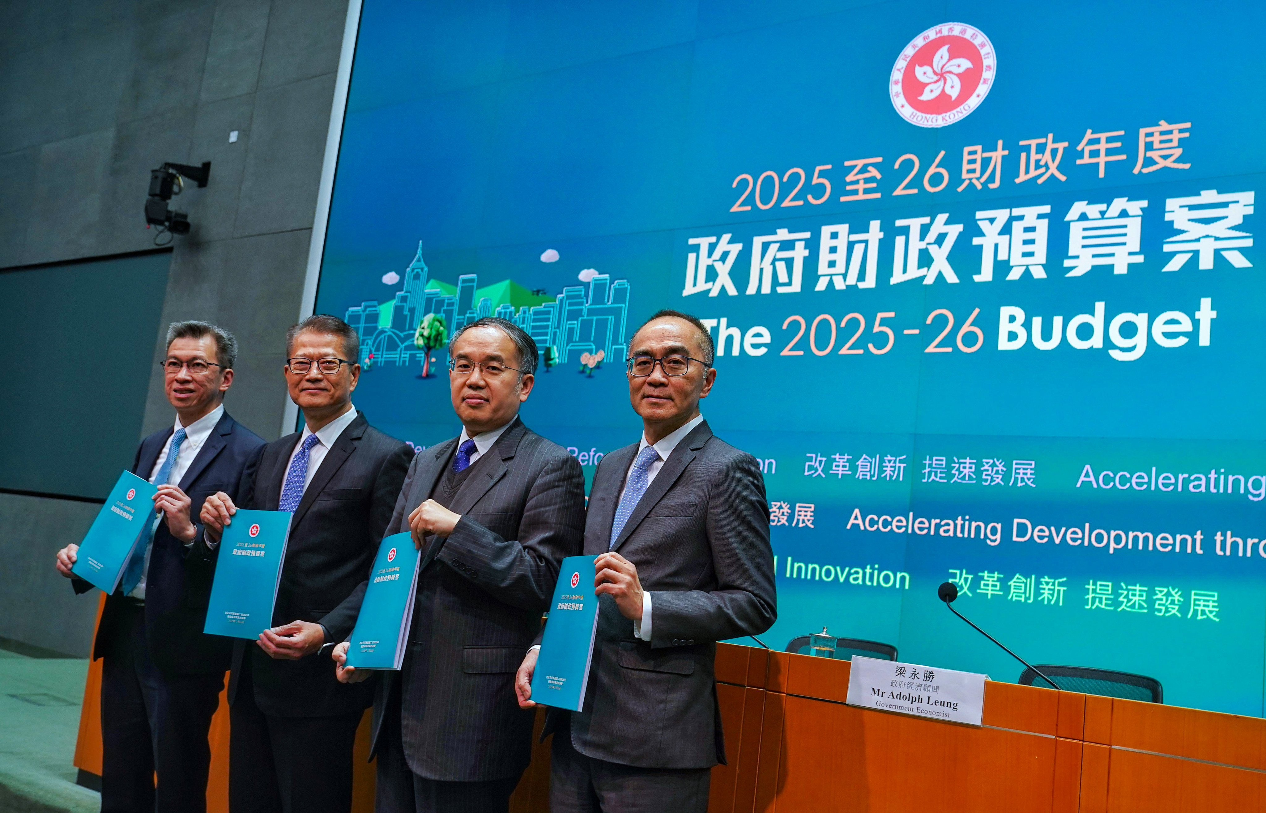 Paul Chan (second from left) with his latest budget blueprint. Photo: Elson Li