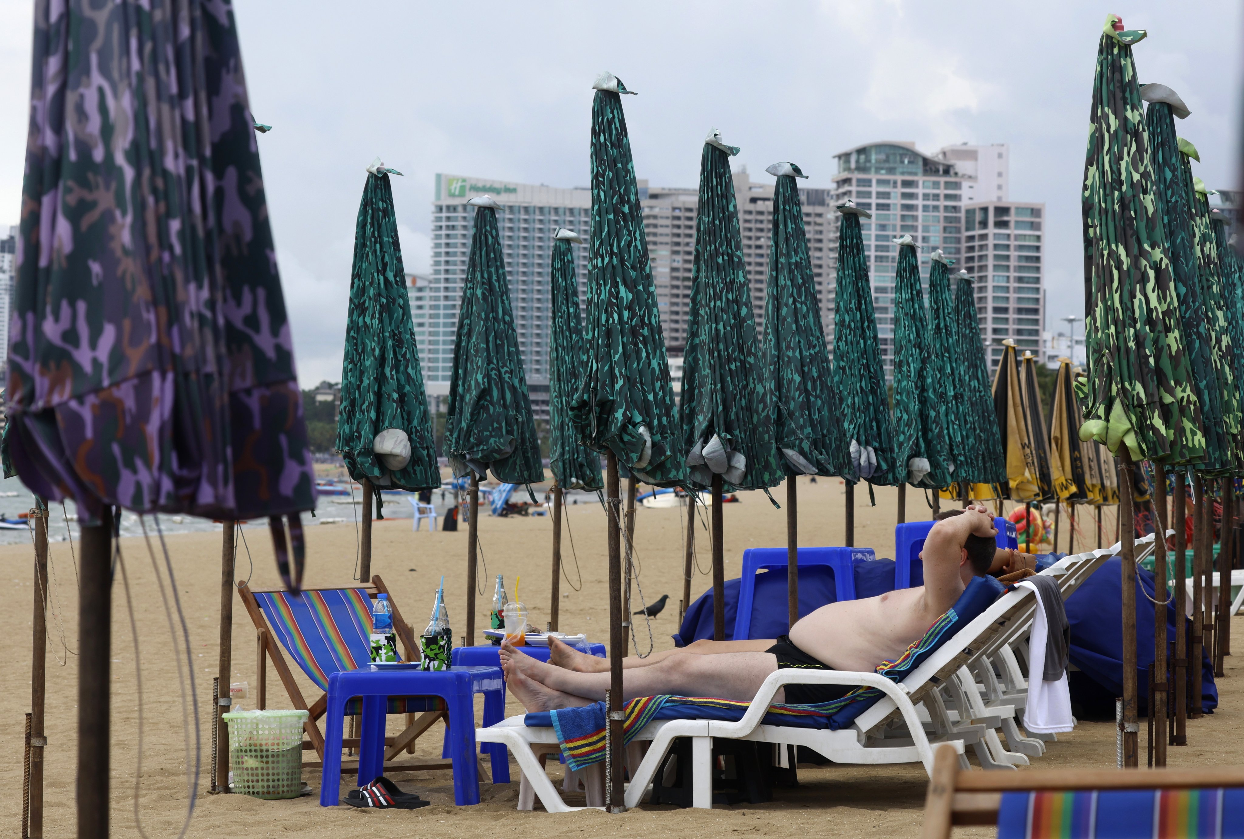 A foreign tourist sunbathes on a beach in Pattaya in Thailand. Photo: EPA-EFE