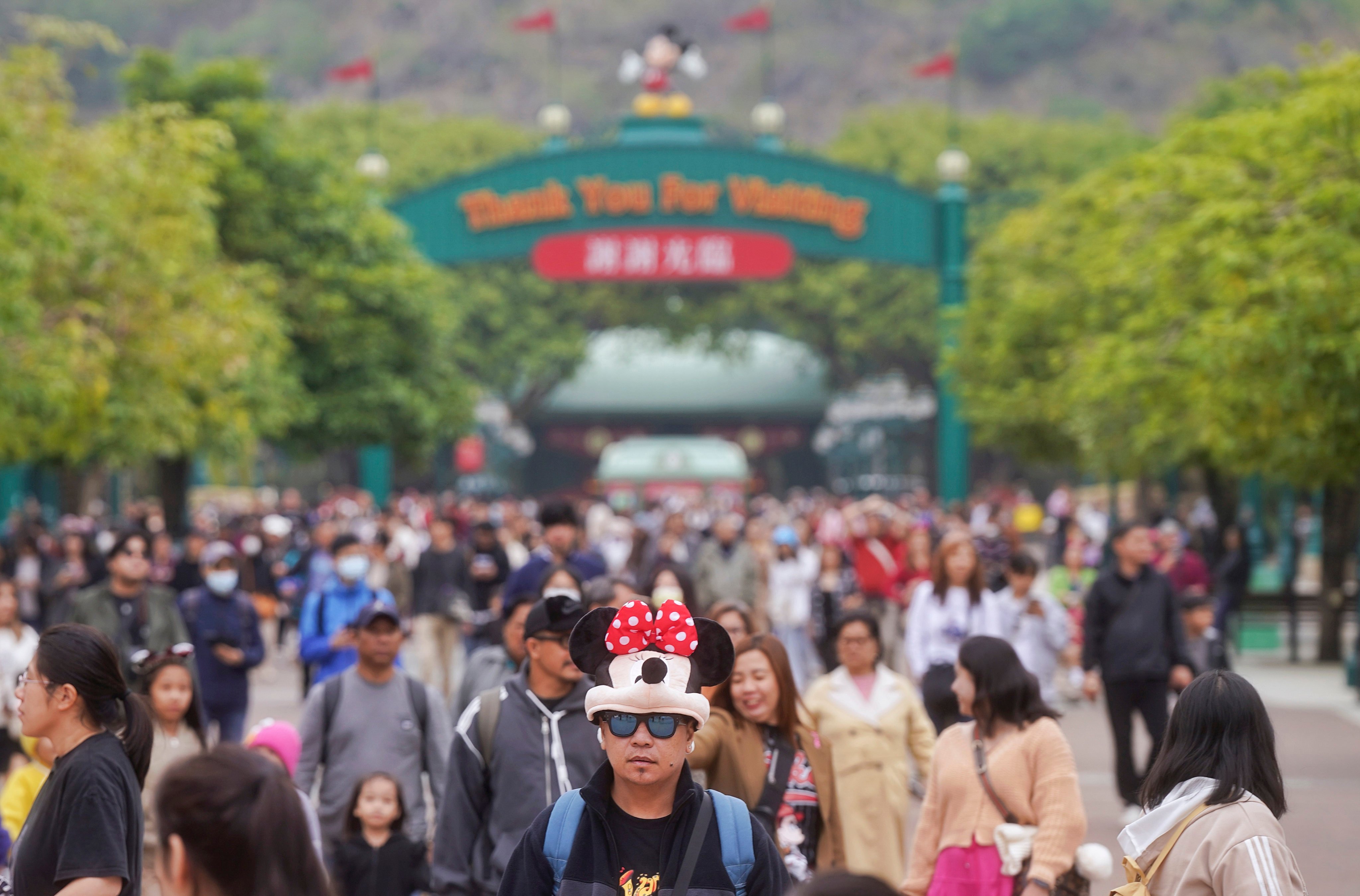 A man wearing a Minnie Mouse accessory on his head is among visitors to Hong Kong Disneyland Resort on February 25. Photo: Elson Li