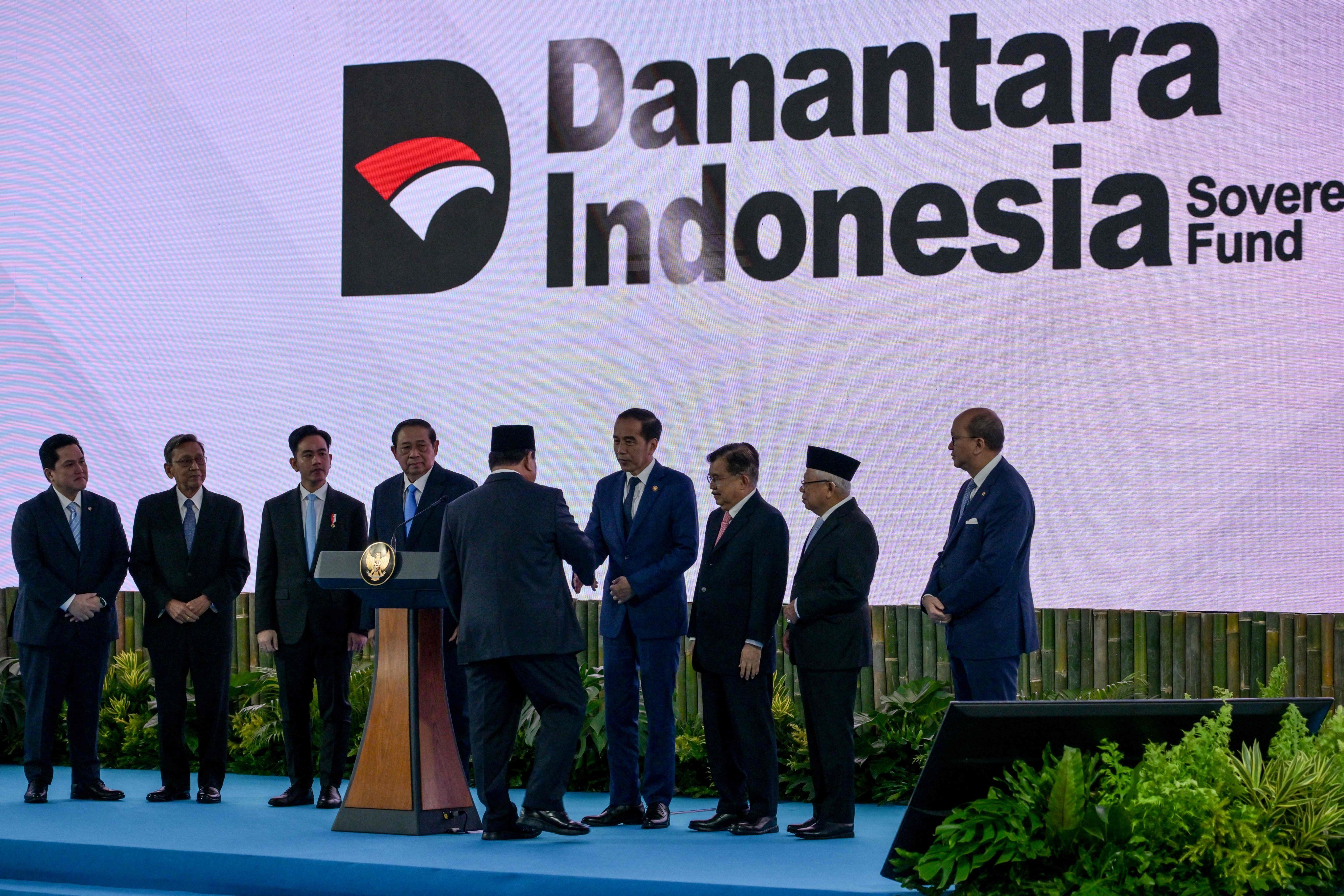 Indonesia’s President Prabowo Subianto shakes hands with former president Joko Widodo during the launch of the Danantara sovereign wealth fund on February 24. Photo: AFP