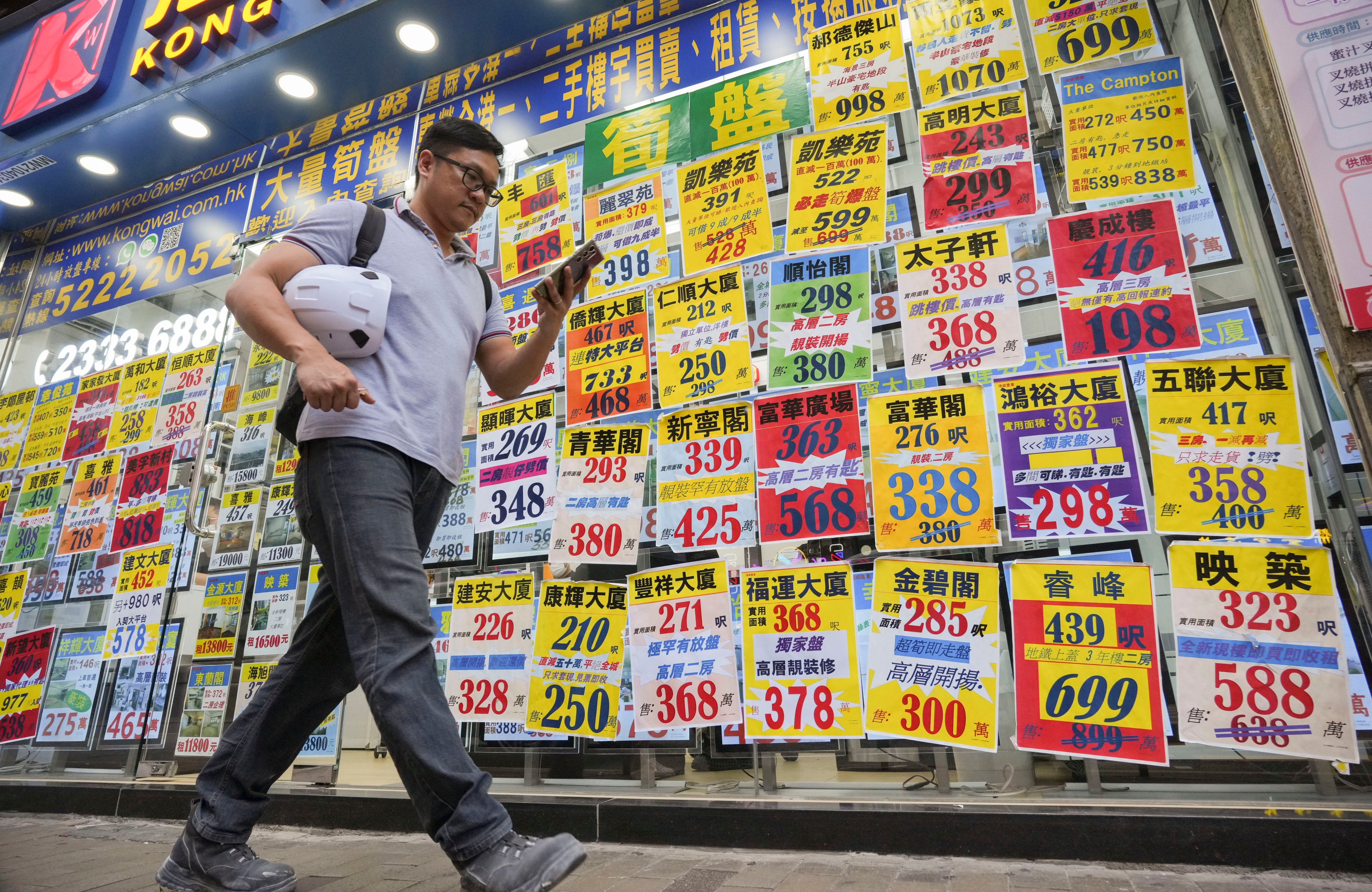 A man passes a real estate agency in Cheung Sha Wan. Photo: May Tse