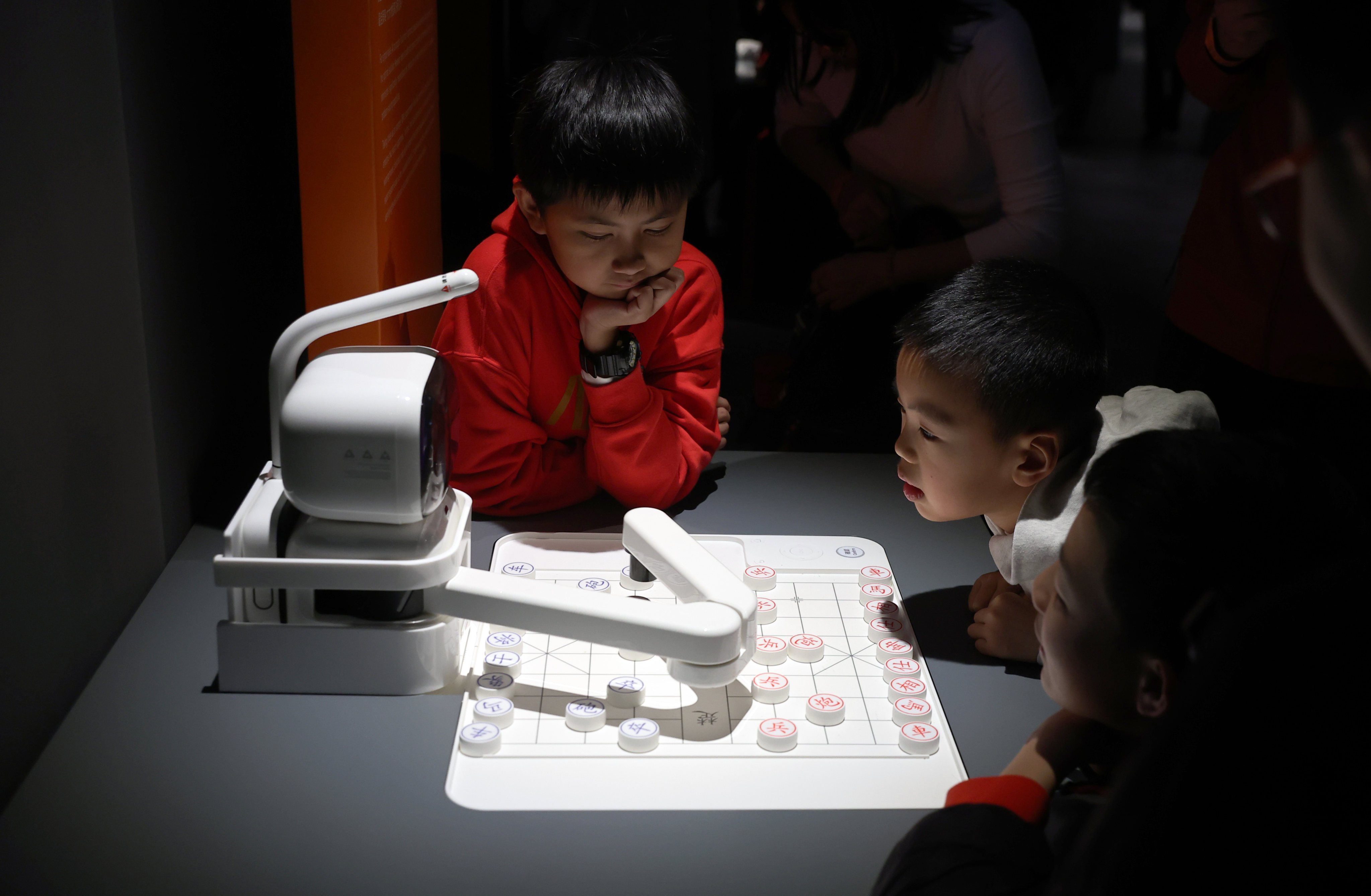 Children gathered around an AI chess player in an exhibition on China’s developments over the past 75 years, at the Hong Kong Science Museum in Tsim Sha Tsui on February 3. Photo: Edmond So