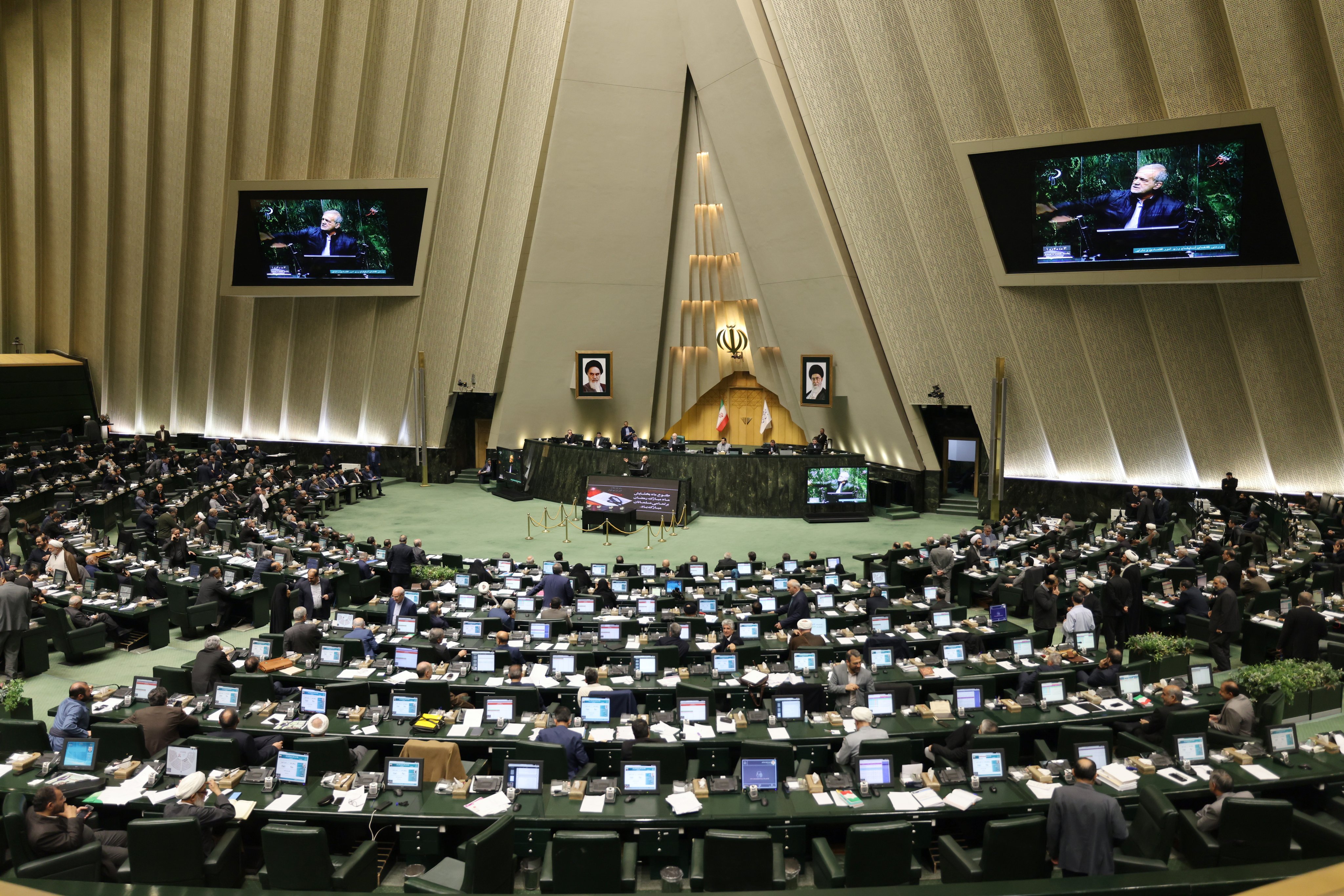 Iranian President Masoud Pezeshkian (C) speaks during a Parliament session to defend his Minister of Economy and Finance at the Iranian Parliament in Tehran, Iran, on Sunday. Photo: EPA-EFE