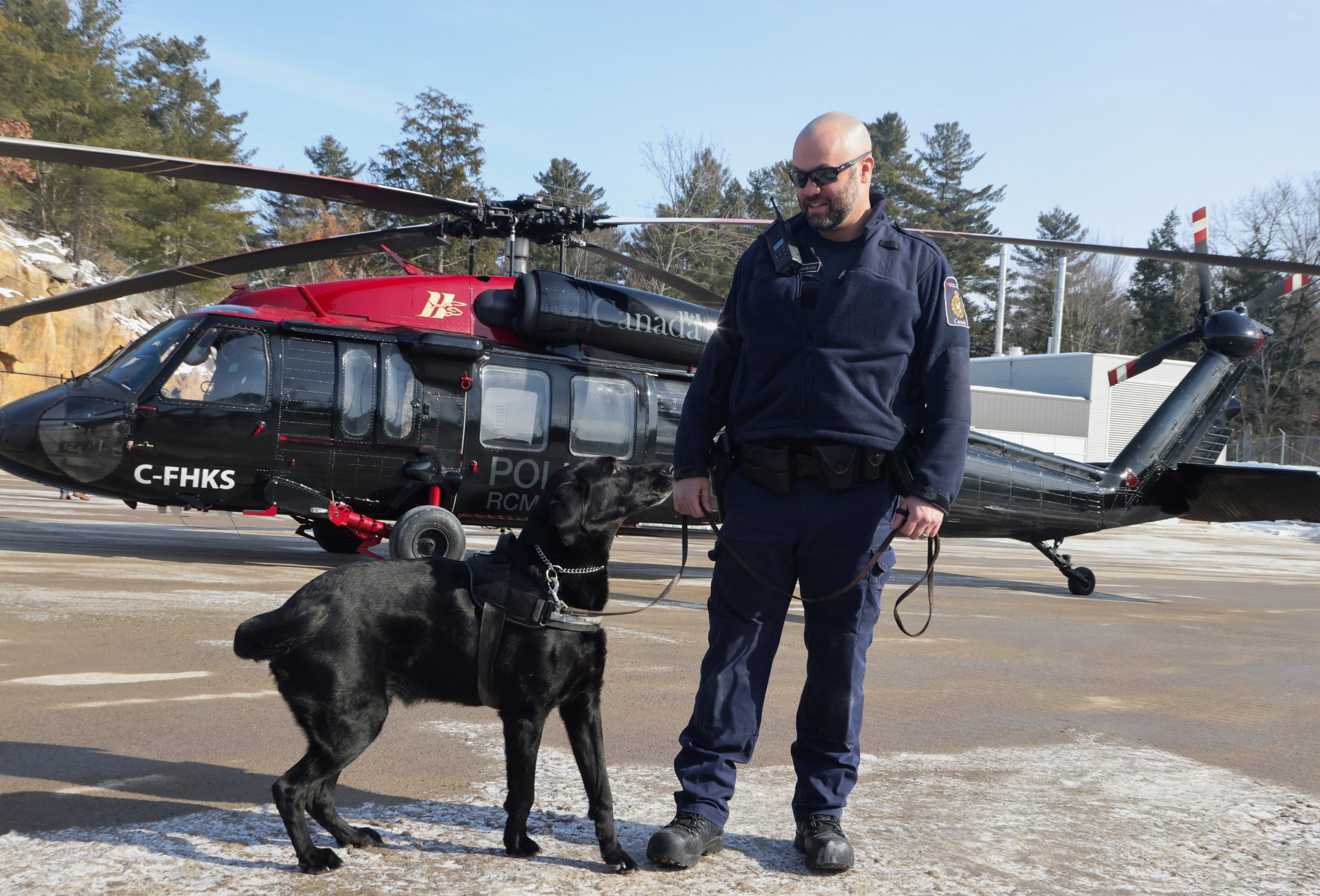 A drug-sniffing dog with its handler in Ontario. Photo: Reuters