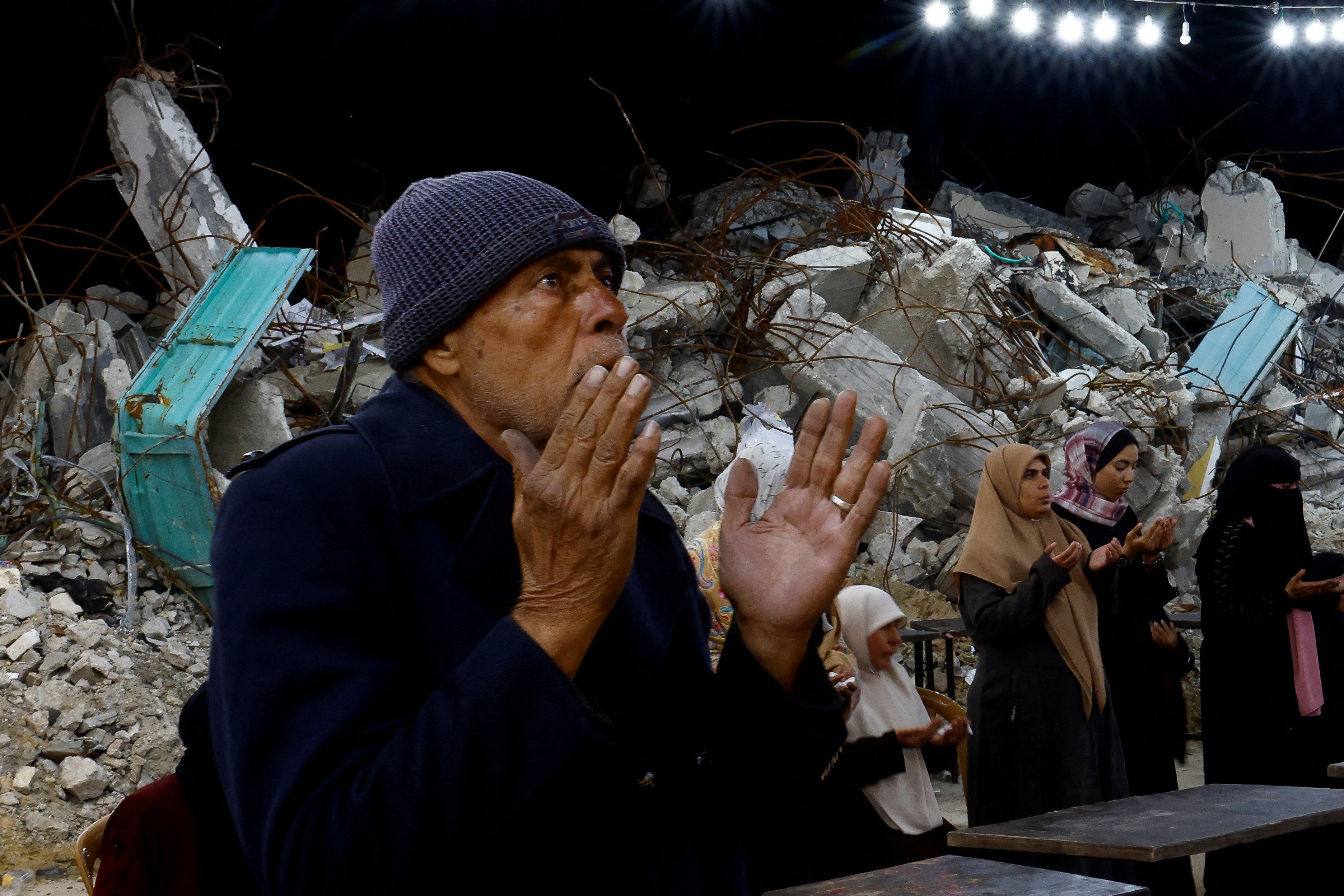 Palestinians pray amid the rubble in Rafah, in the southern Gaza Strip, on Saturday, during the holy fasting month of Ramadan. Photo: Reuters