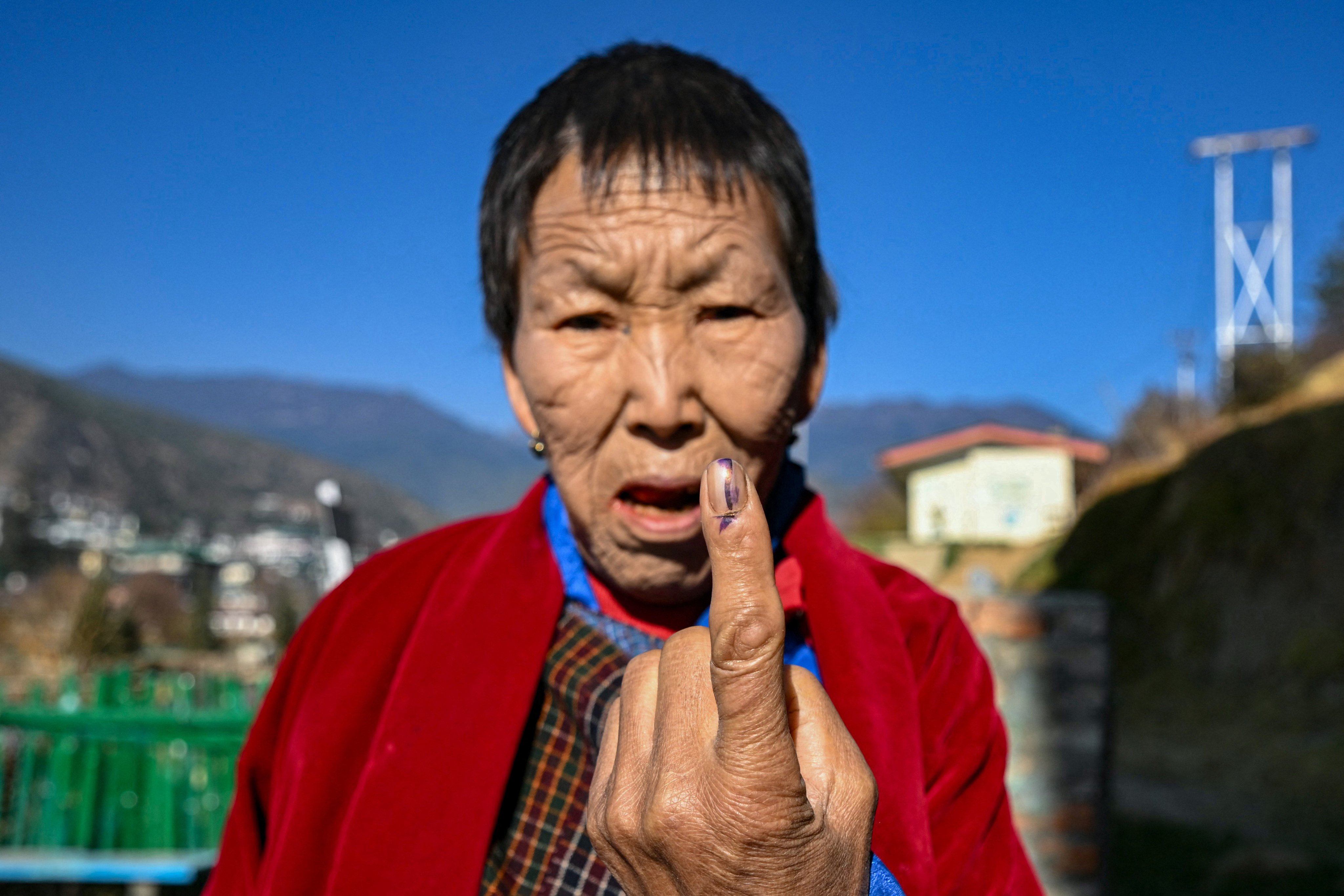 A Bhutanese voter shows an indelible ink mark on her finger after casting her vote at a polling station in Thimphu during general elections in January 2024. Photo: AFP