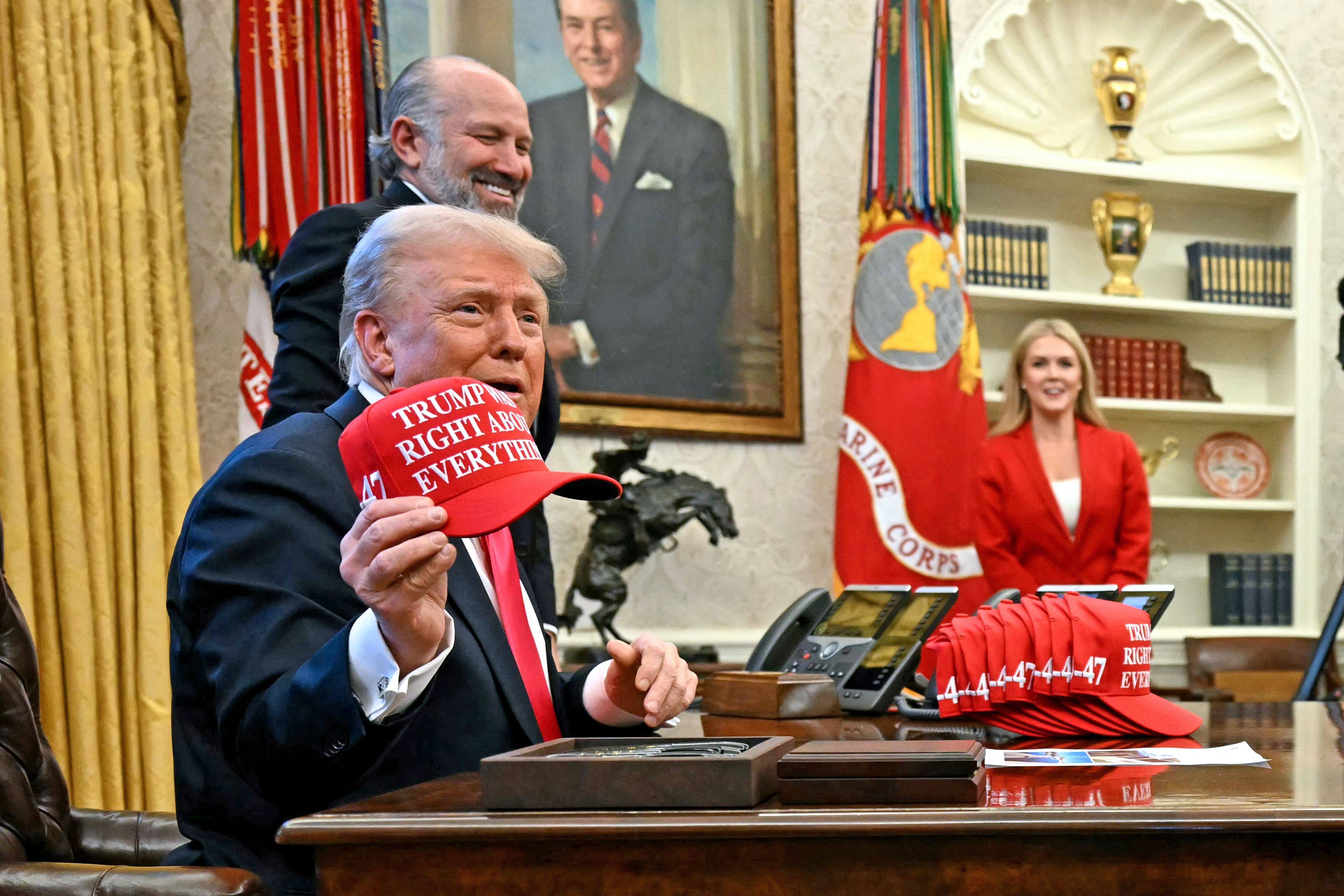 US President Donald Trump holds a cap reading “Trump was right about everything” after signing an executive order at the Oval Office of the White House in Washington on February 25. Photo: AFP