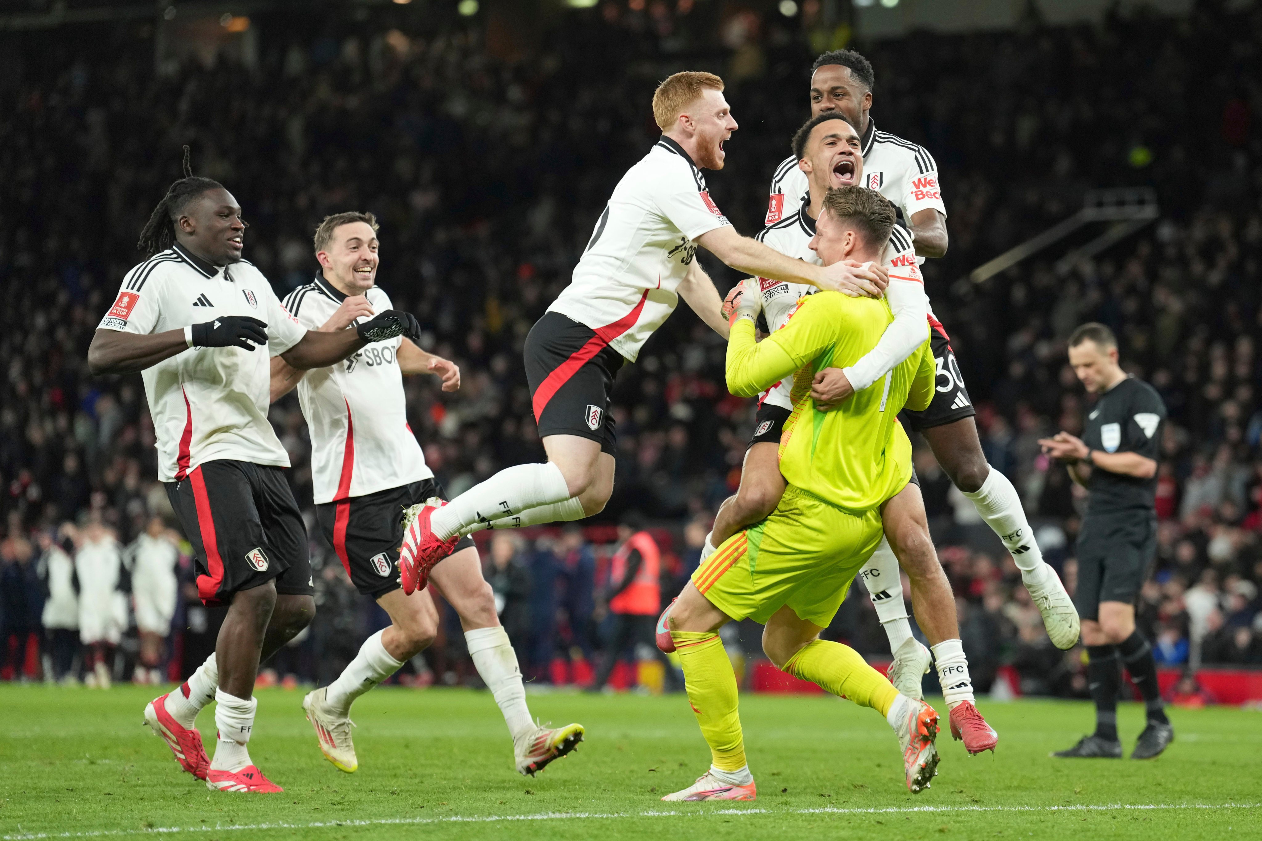 Fulham players celebrate after beating Manchester United in a penalty shootout at Old Trafford. Photo: AP