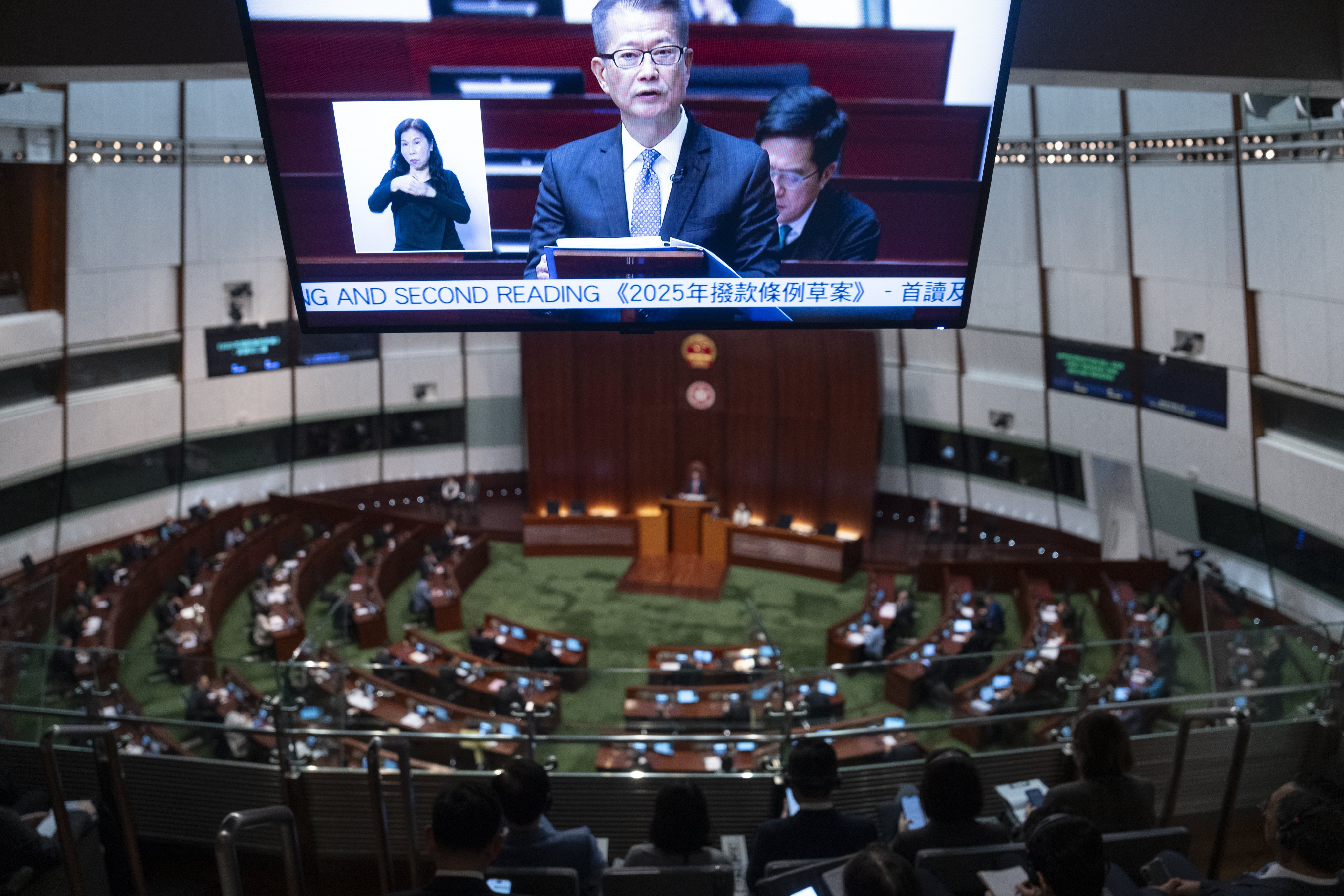 A screen displays Hong Kong’s Financial Secretary Paul Chan Mo-po as he presents the annual budget for 2025-26 at the Legislative Council of Hong Kong on Wednesday. Photo: EPA-EFE