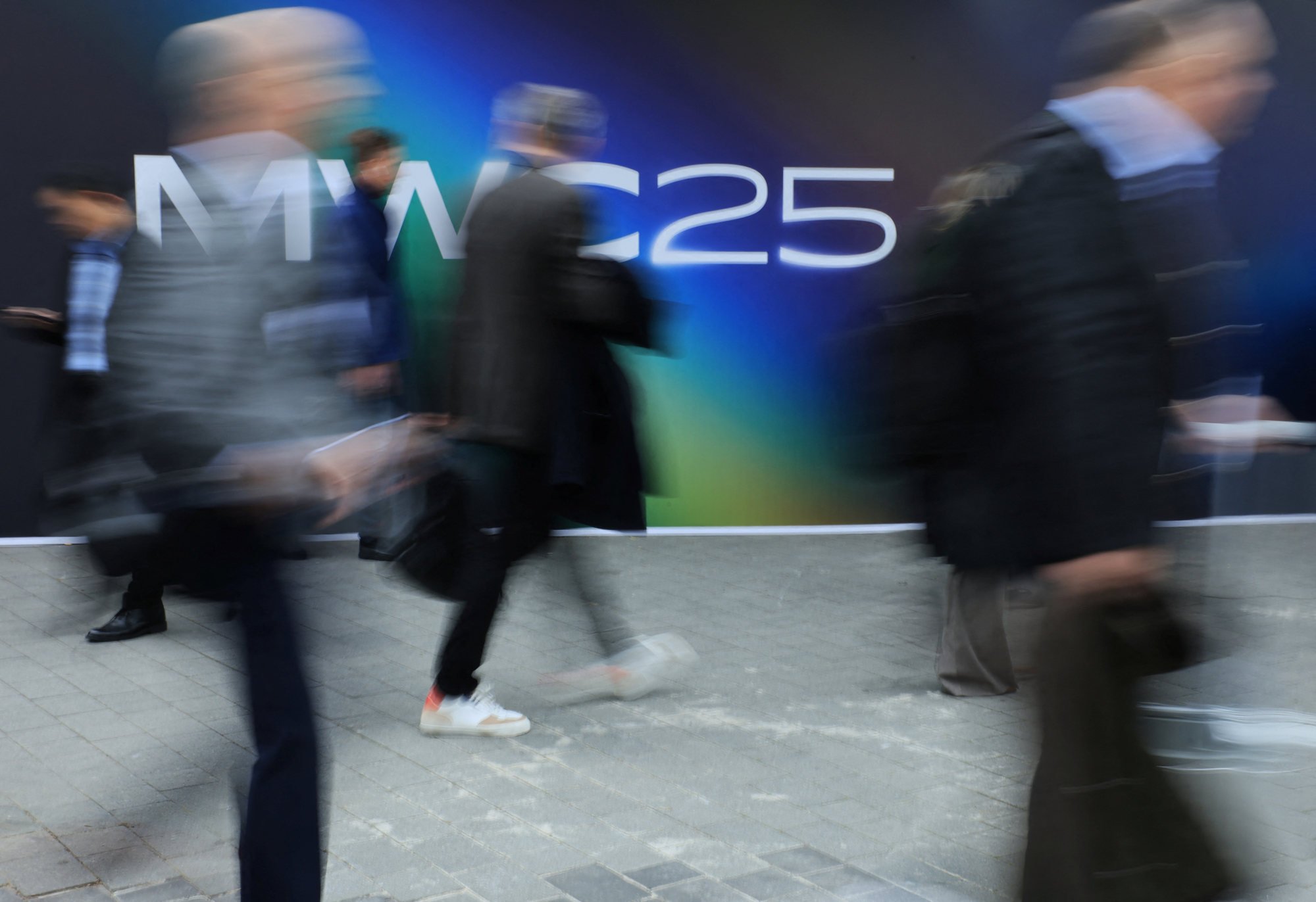 Delegates and visitors arrive at MWC Barcelona in Spain. Photo: Reuters Delegates and visitors arrive at MWC Barcelona in Spain. Photo: Reuters