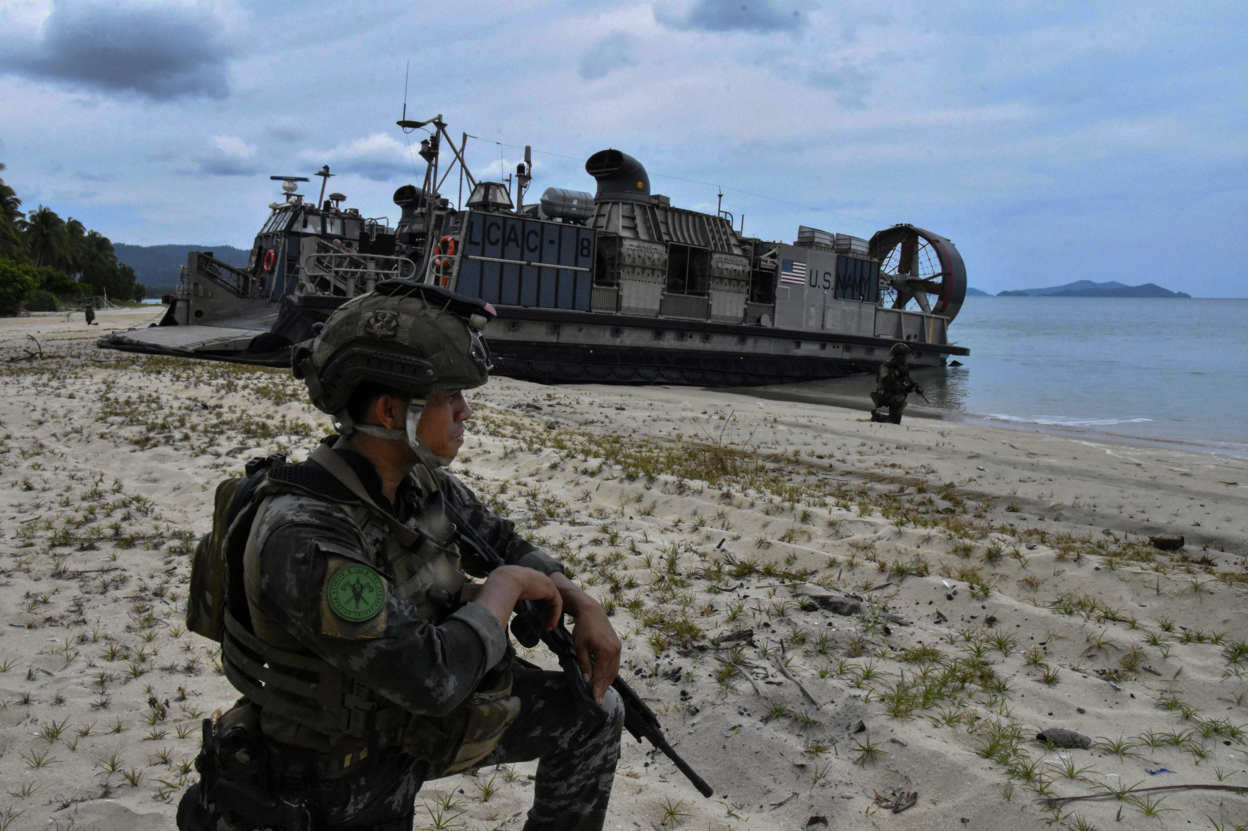 A Philippine soldier guards a US military hovercraft during an annual bilateral military exercise in May last year in San Vicente, Palawan Province, the Philippines. Photo: Kyodo