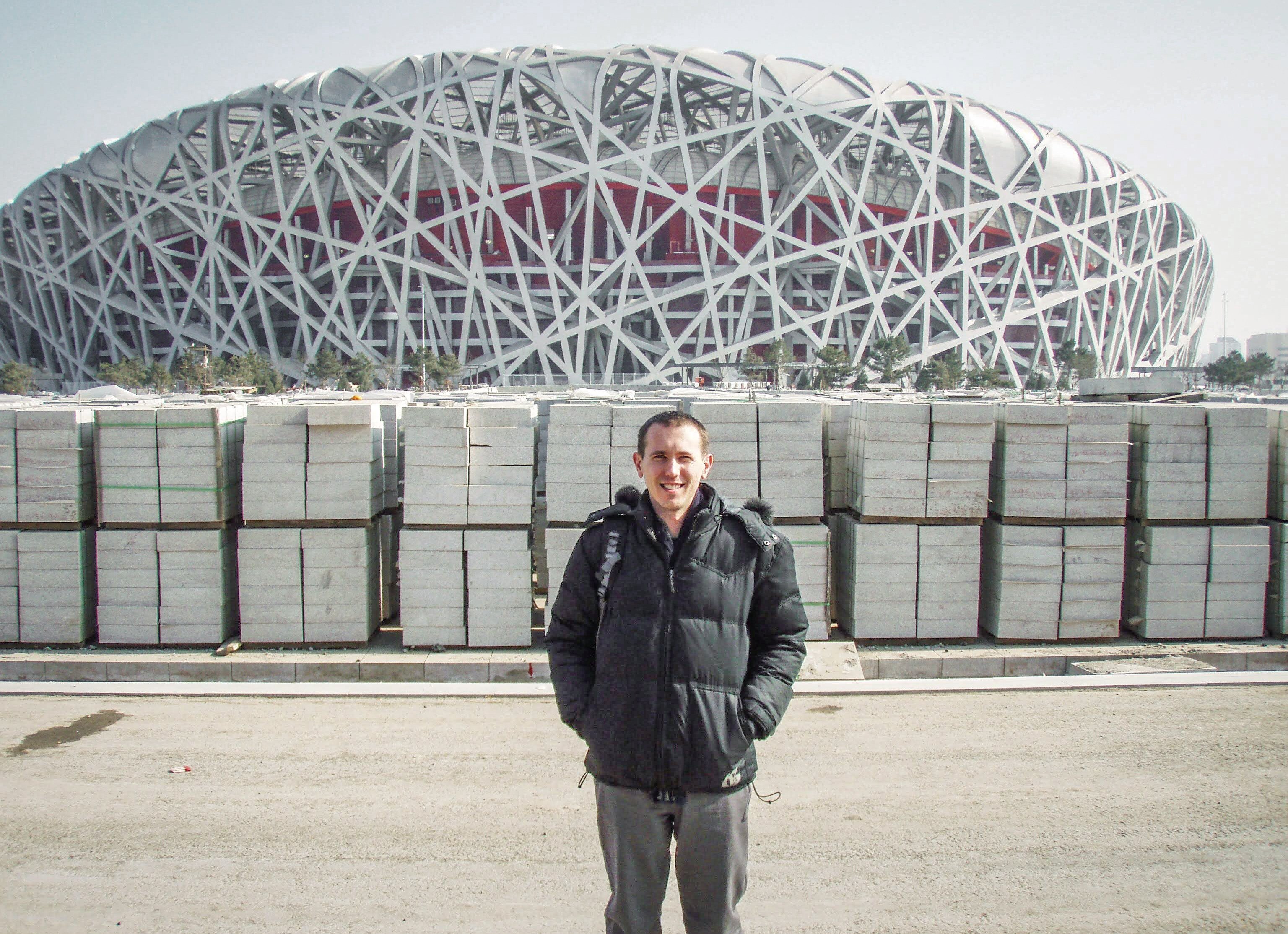 Glen Loveland poses in front of Beijing’s Olympic Stadium. Photo: Courtesy of Glen Loveland