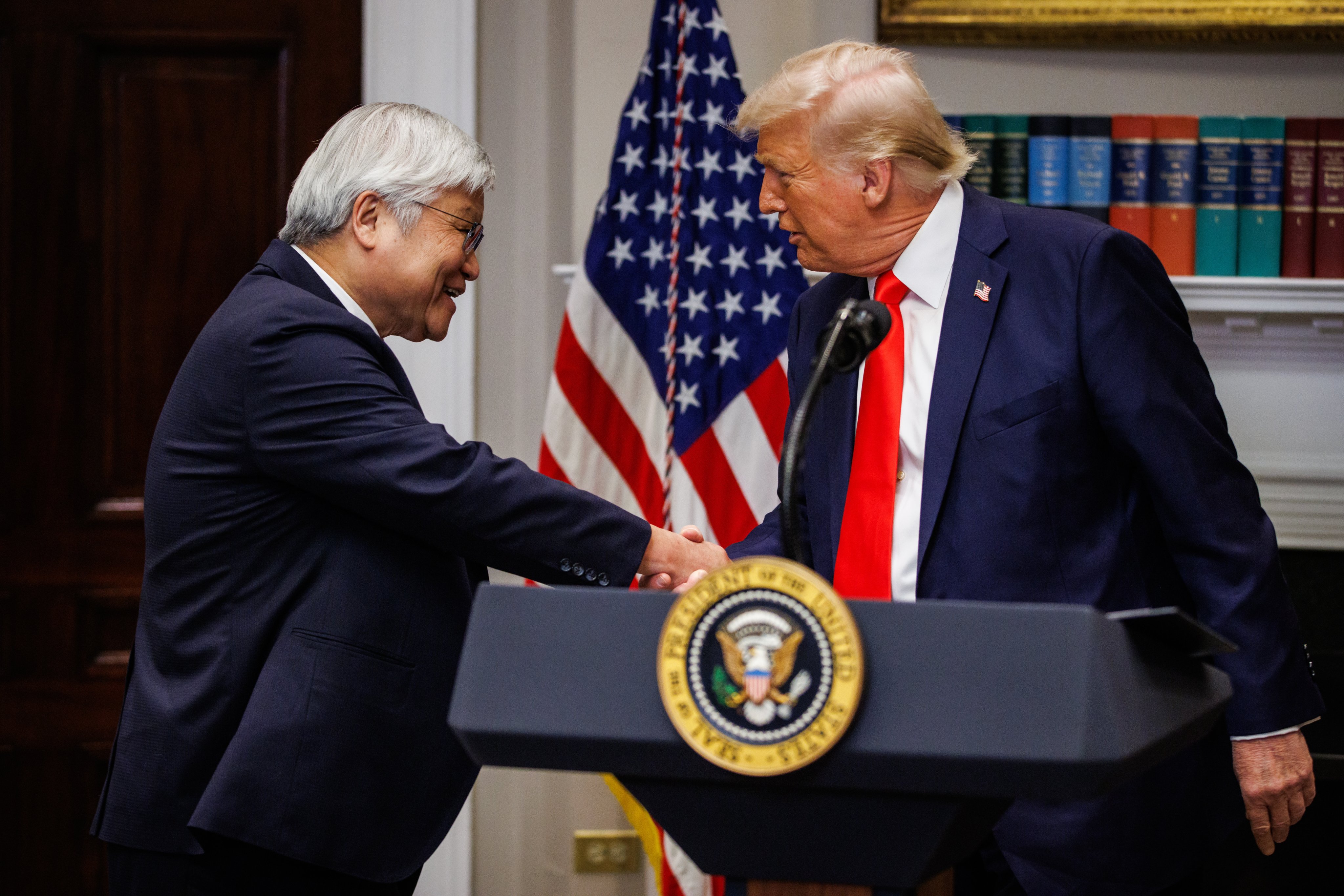 US President Donald Trump and TSMC CEO C.C. Wei shake hands in the White House in Washington on Monday. Photo: EPA-EFE