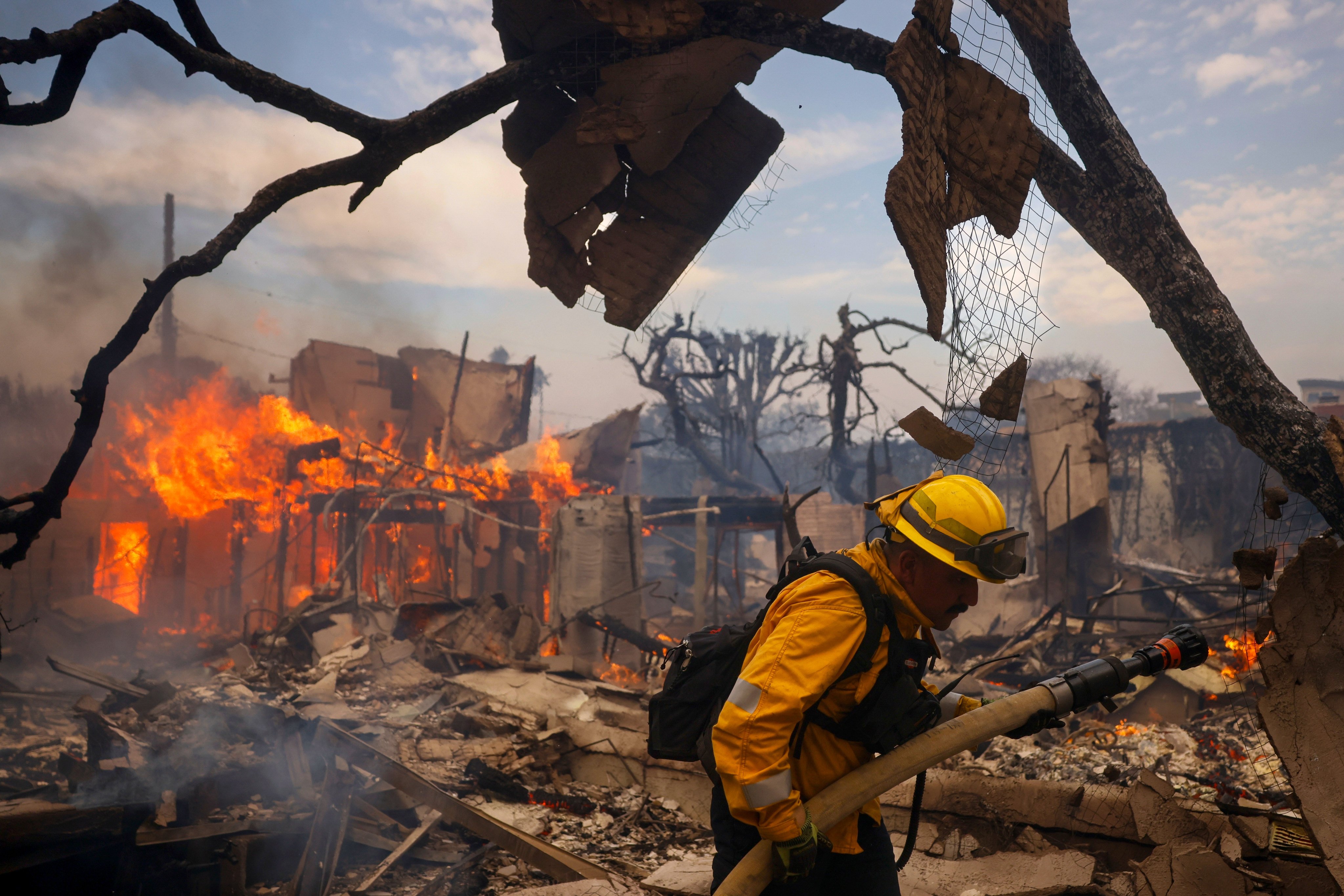 A firefighter battles the Palisades Fire near a burned structure in Los Angeles, on January 8. Photo: AP