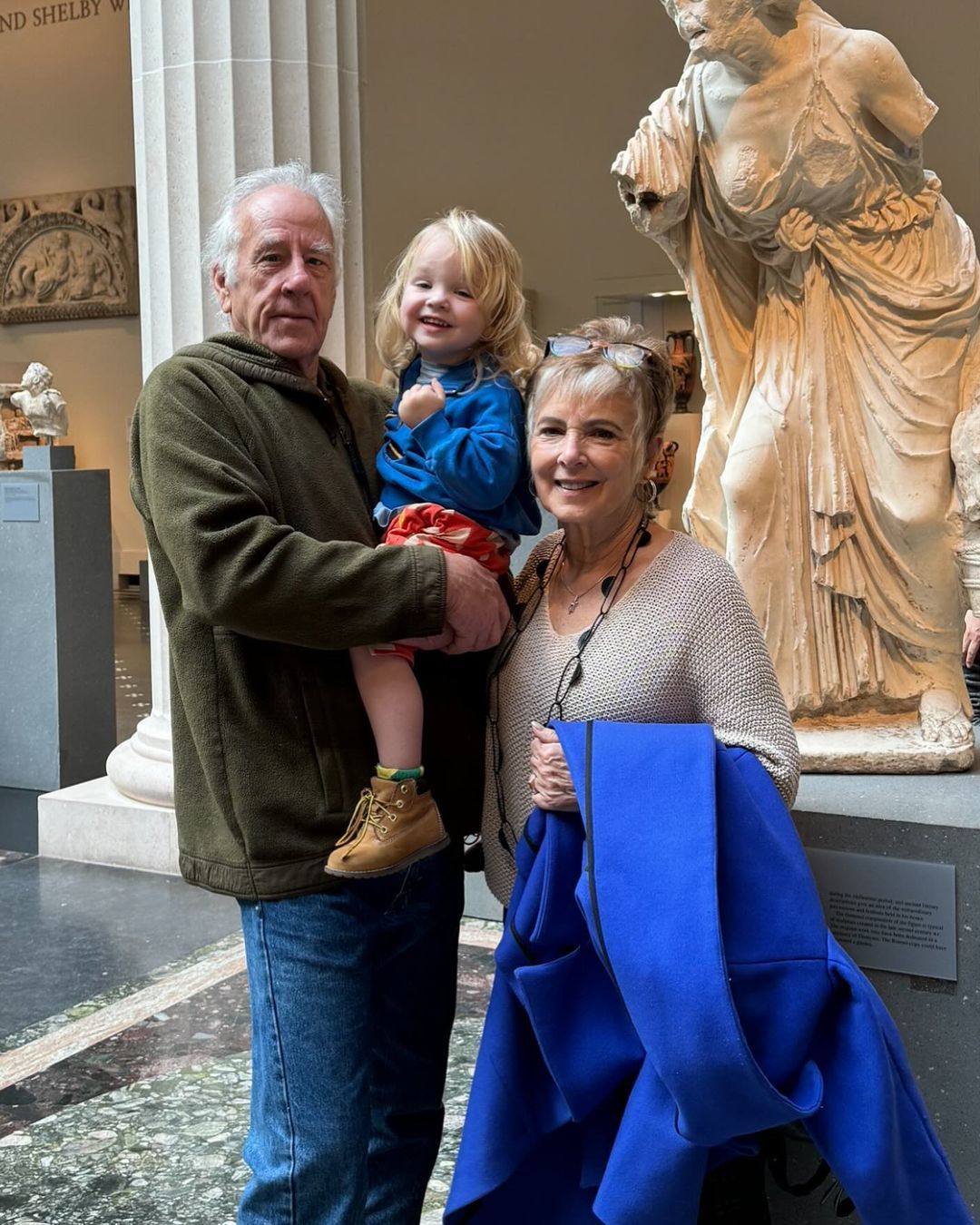 Emily Ratajkowski’s parents, John Ratajkowski and Kathleen Balgley, with their grandson Sly. Photo: @johnratajkowski/Instagram