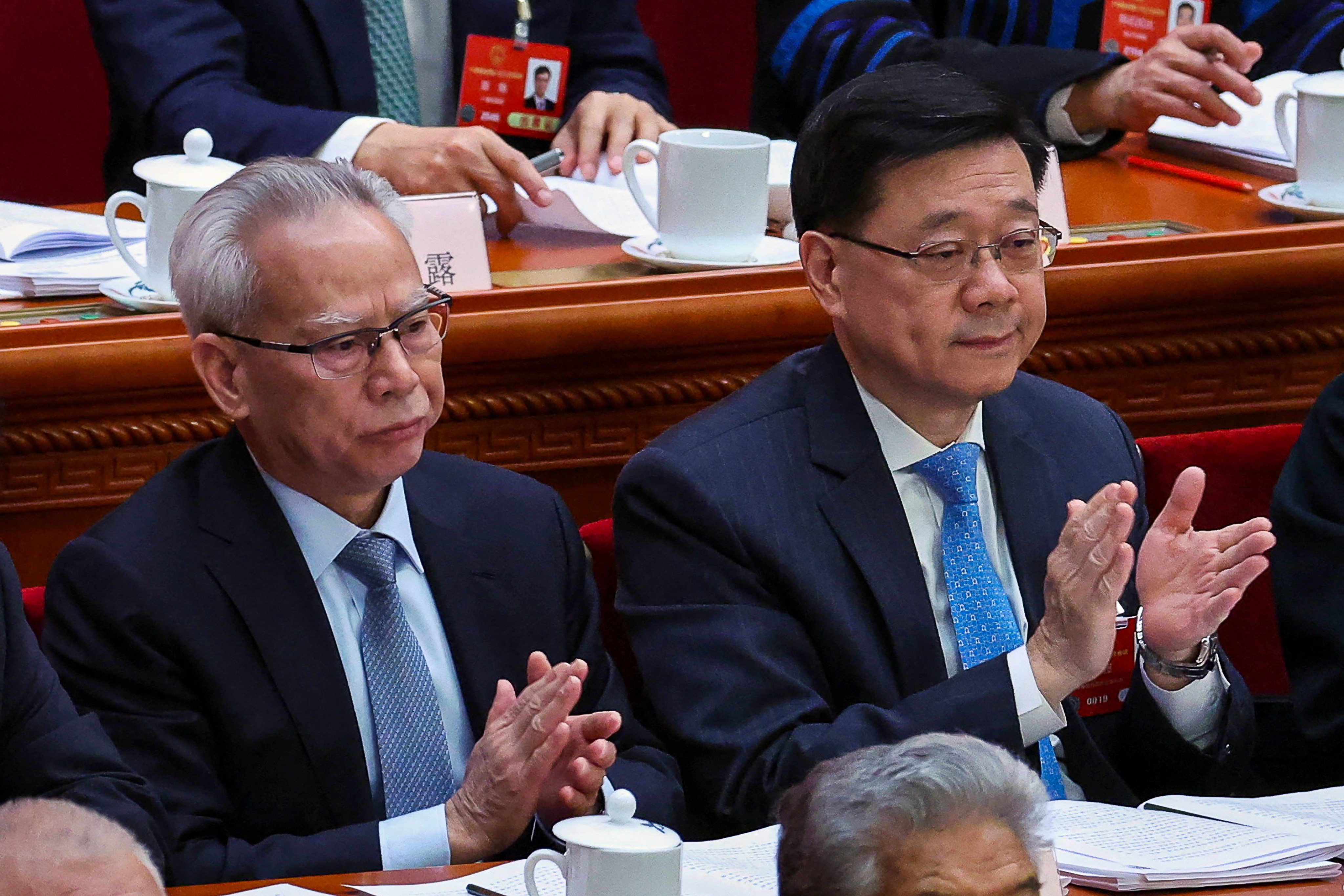 Hong Kong Chief Executive John Lee (right) and his Macau counterpart Sam Hou Fai at the opening session of the National People’s Congress at the Great Hall of the People in Beijing on Wednesday. Photo: Reuters