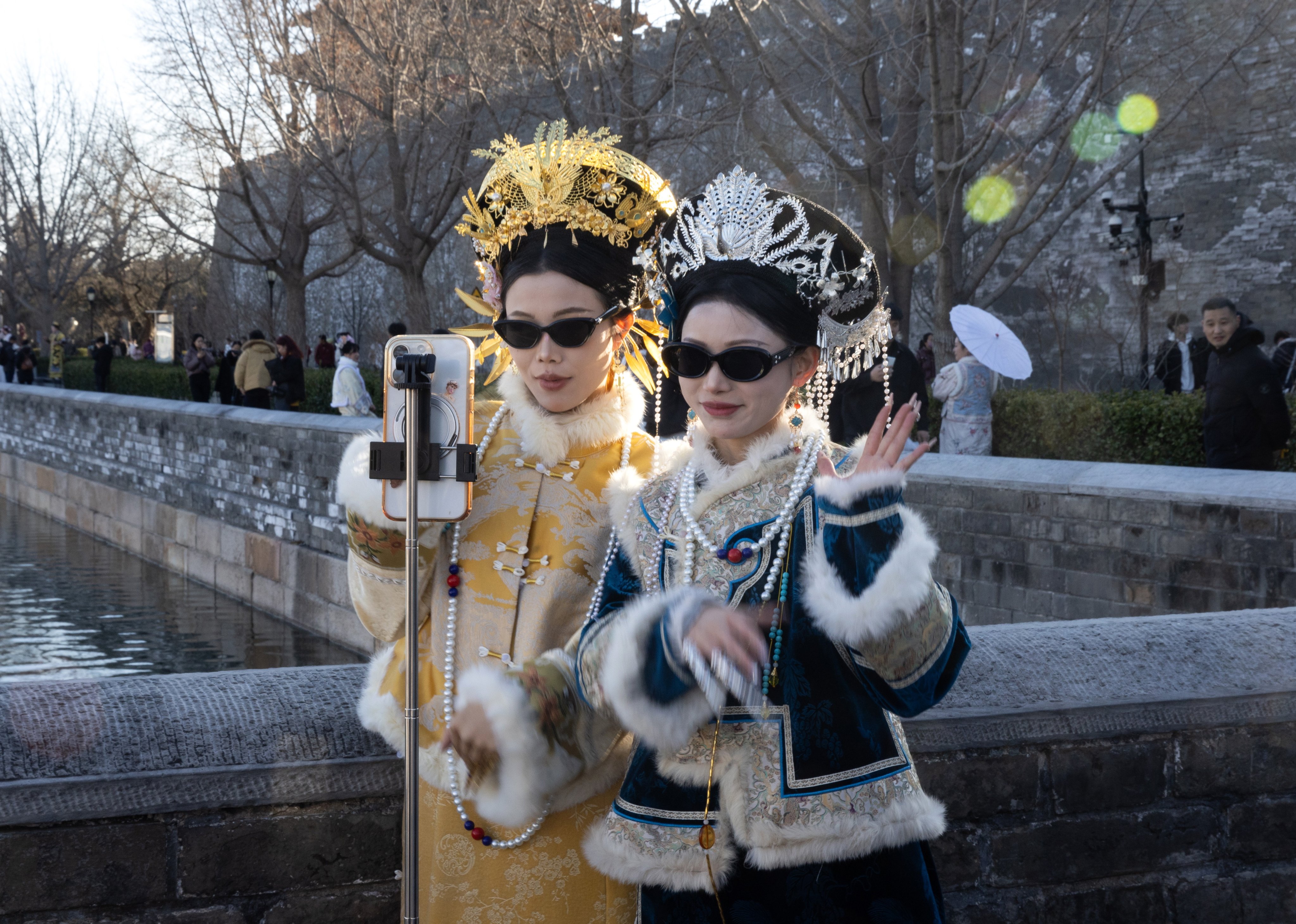 Women in period costume record a dance with a phone in Beijing on February 25. Photo: EPA-EFE