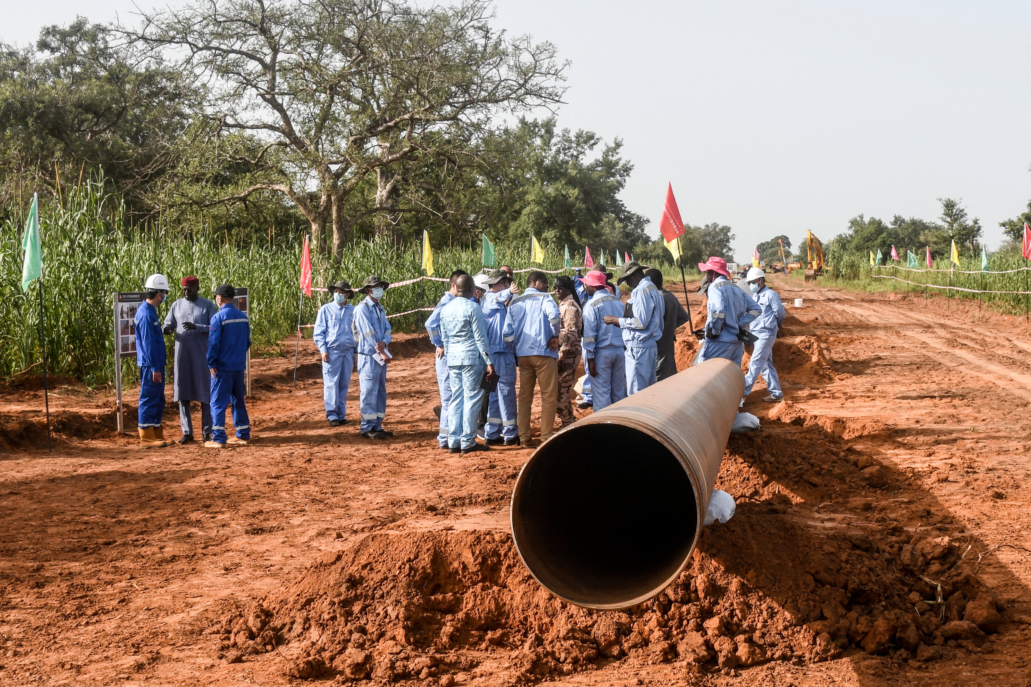 Workers from Niger and China work on an oil pipeline, one of the scores of Chinese-funded projects across the continent. Photo: AFP