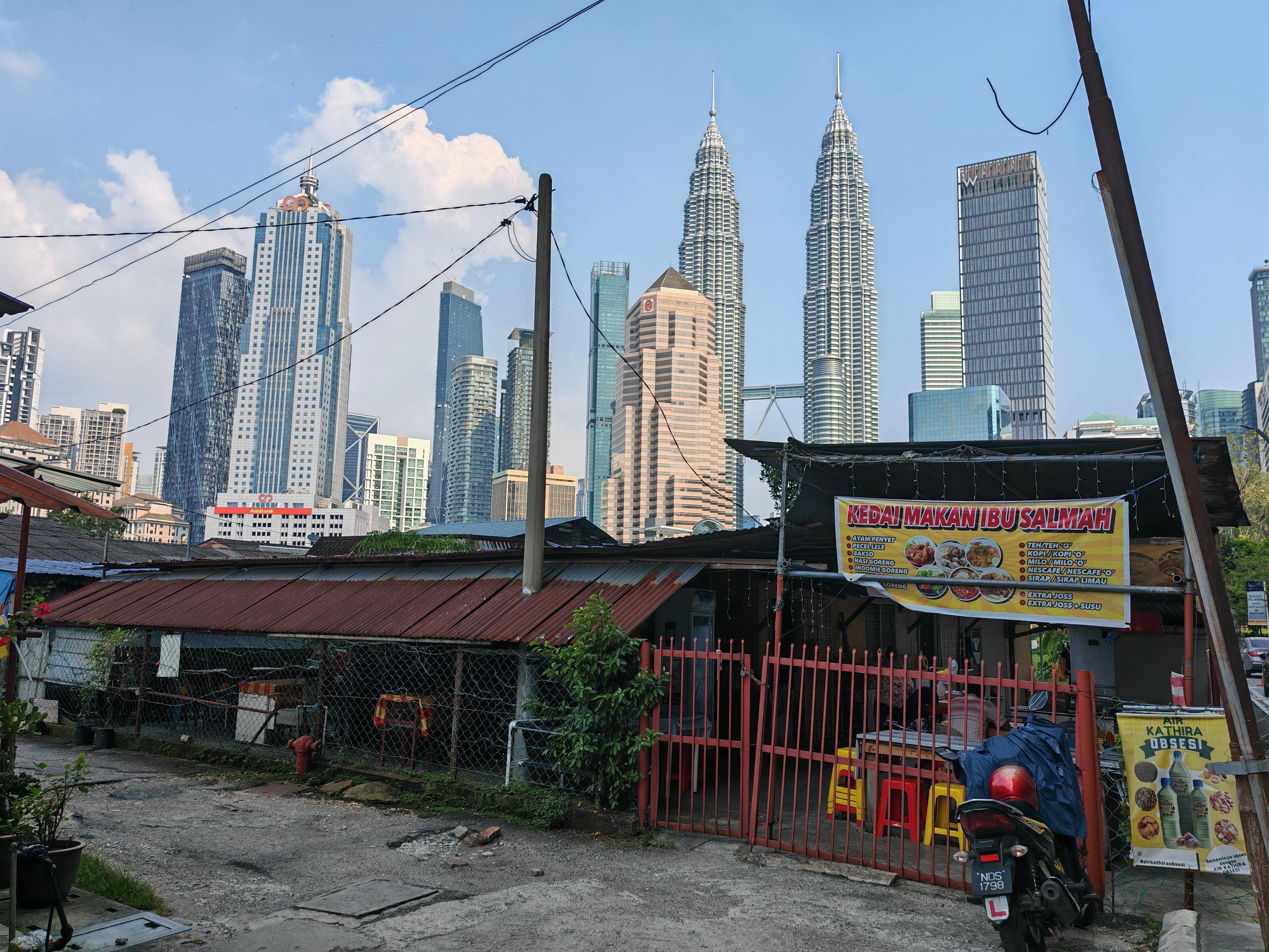 Kuala Lumpur’s KLCC Twin Towers and other skyscrapers are seen surrounding Kampung Baru, the city’s last traditional Malay village. Photo: Joseph Sipalan