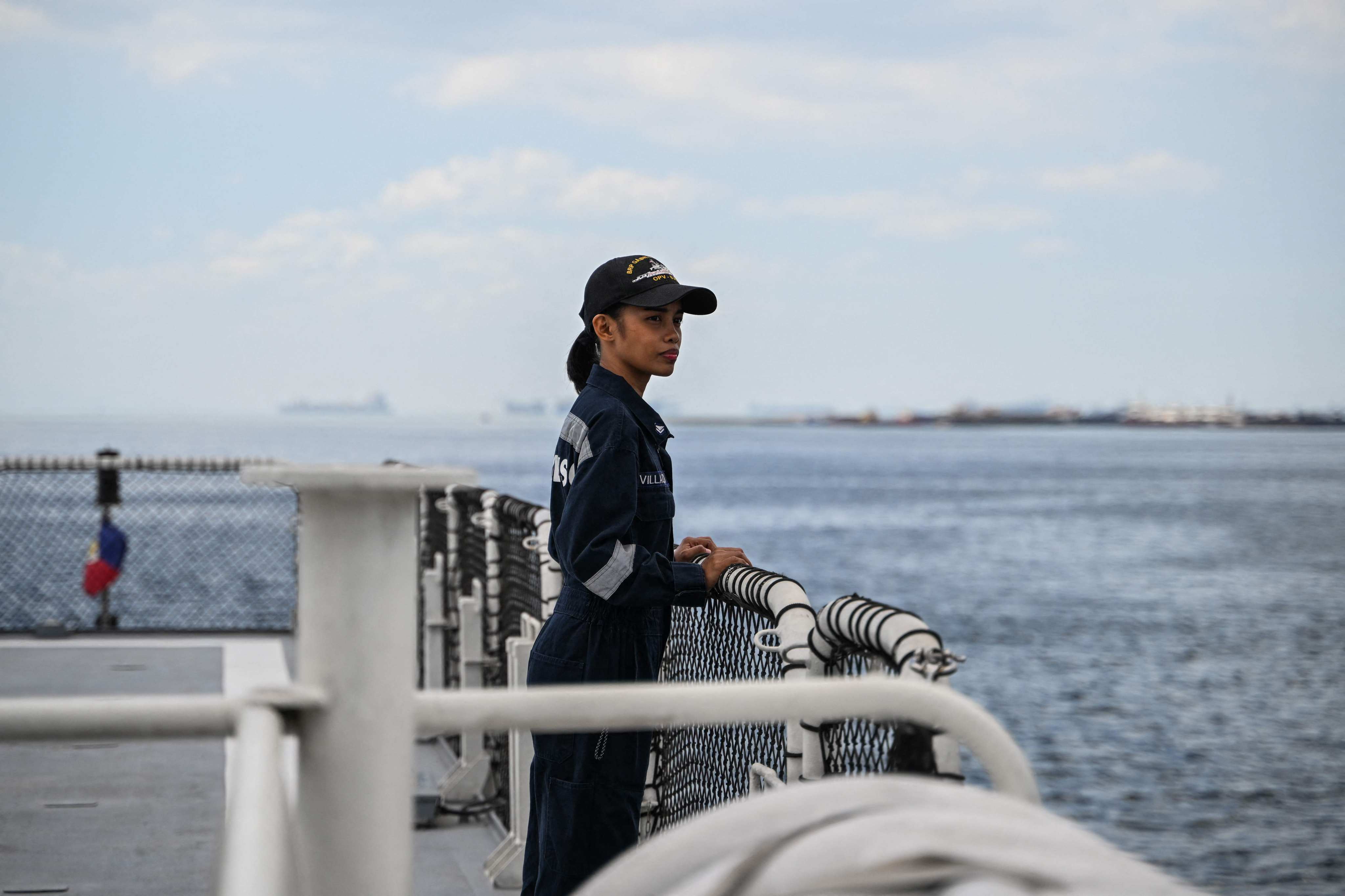 Stephane Villalon, a Philippine coastguard radio operator with the Angels of the Sea programme, looks out to sea on a ship in Manila. Photo: AFP