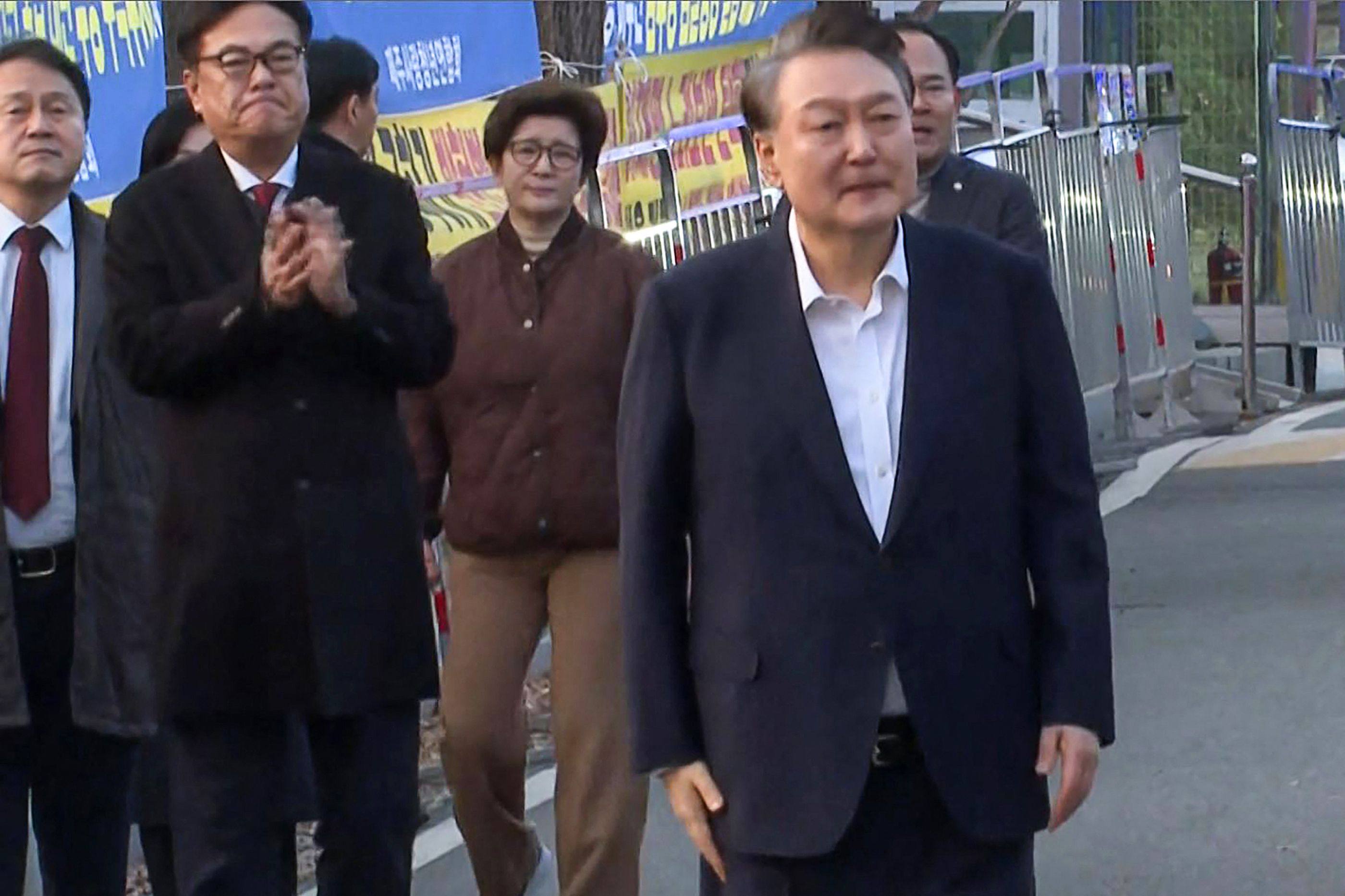 Impeached South Korean President Yoon Suk-yeol (right) walking out of the Seoul Detention Center in Uiwang after he was released on Saturday. Photo: AFP