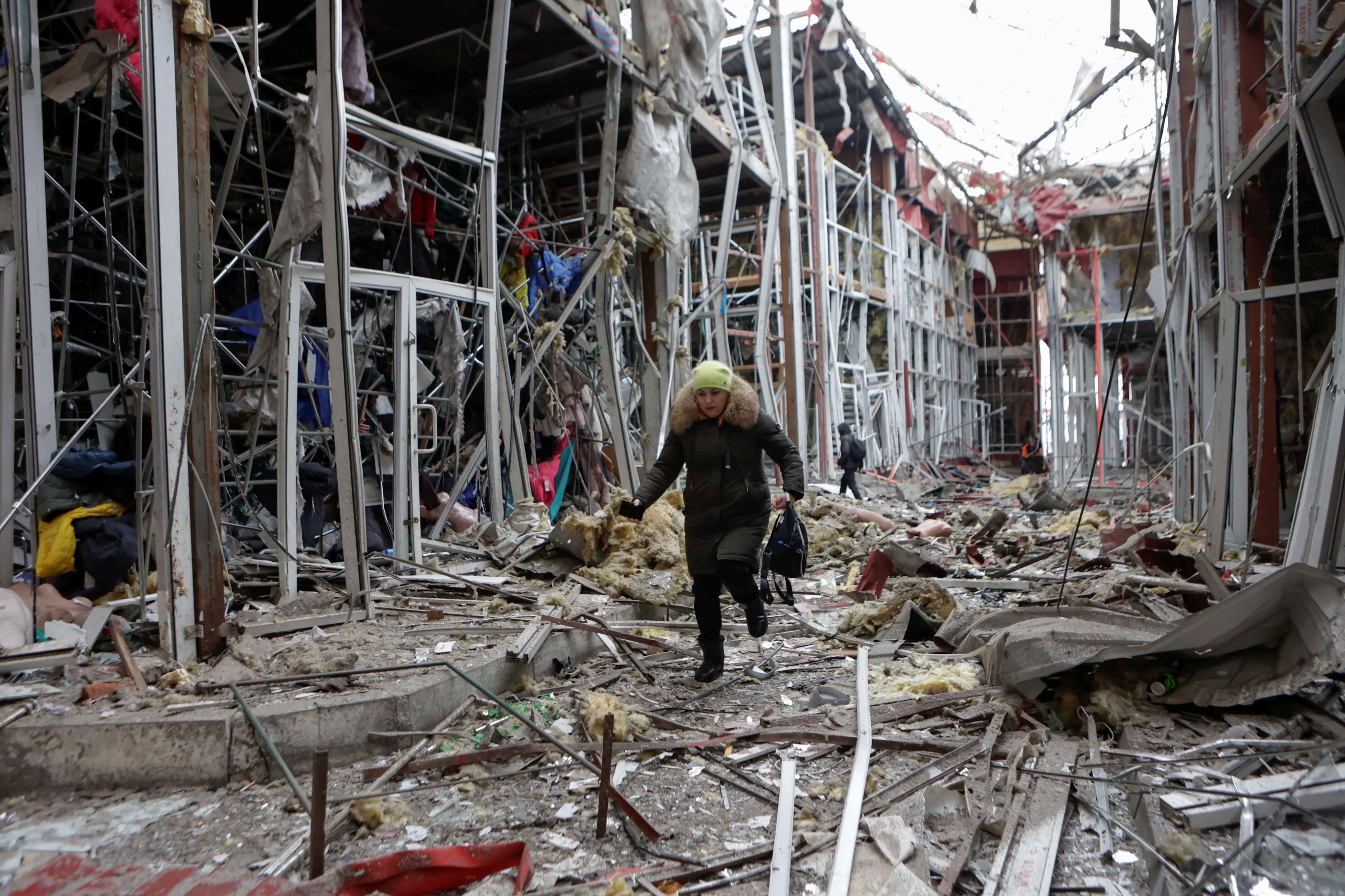 A woman walks on debris at a market hit by a Russian drone strike, in Kharkiv, Ukraine, on February 6. Photo: Reuters