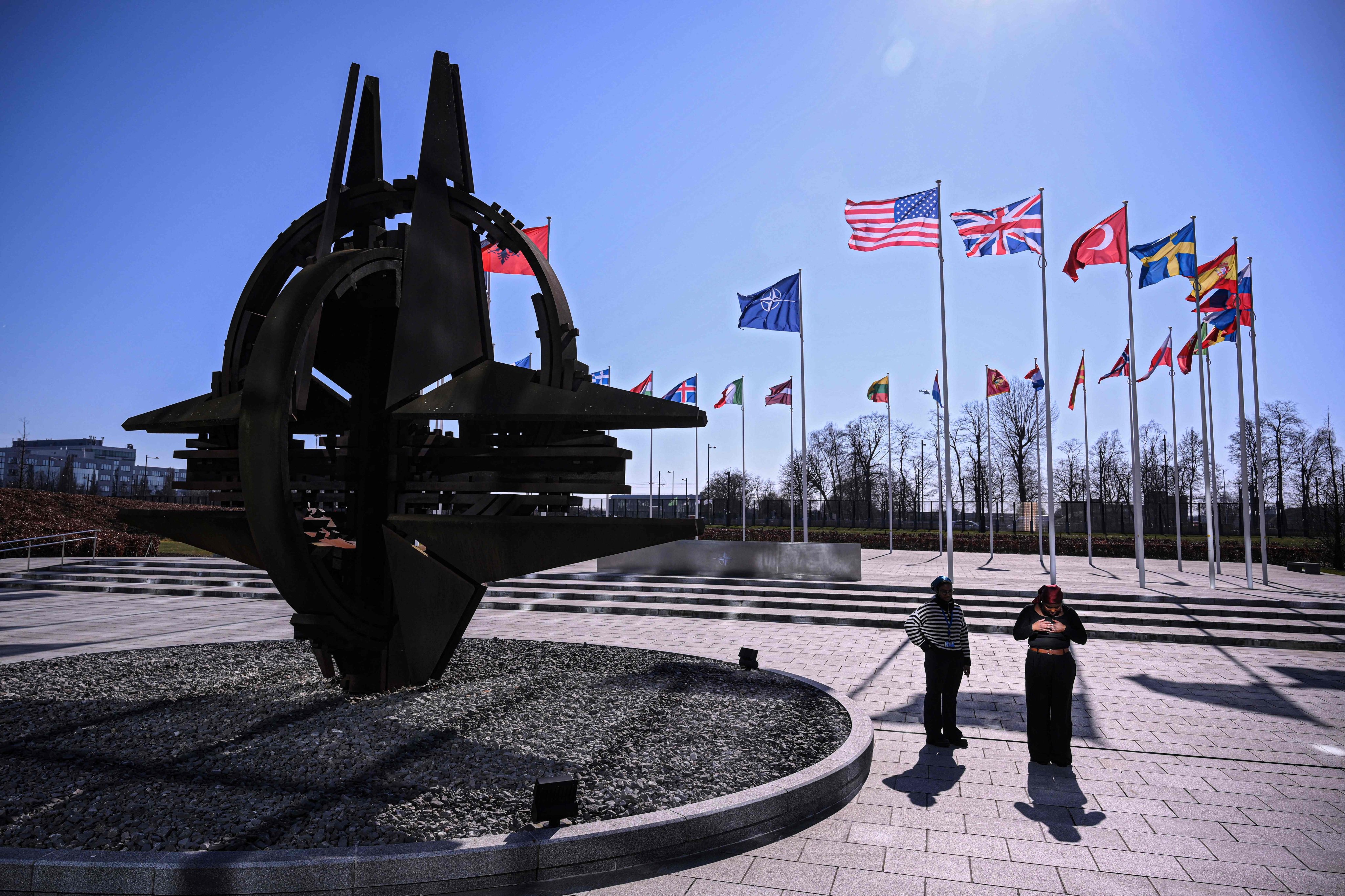 A photo taken on March 6, 2025, shows member nation flags and a sculpture at the Cour d’Honneur of the North Atlantic Treaty Organization (NATO) headquarters, in Brussels. Photo: AFP