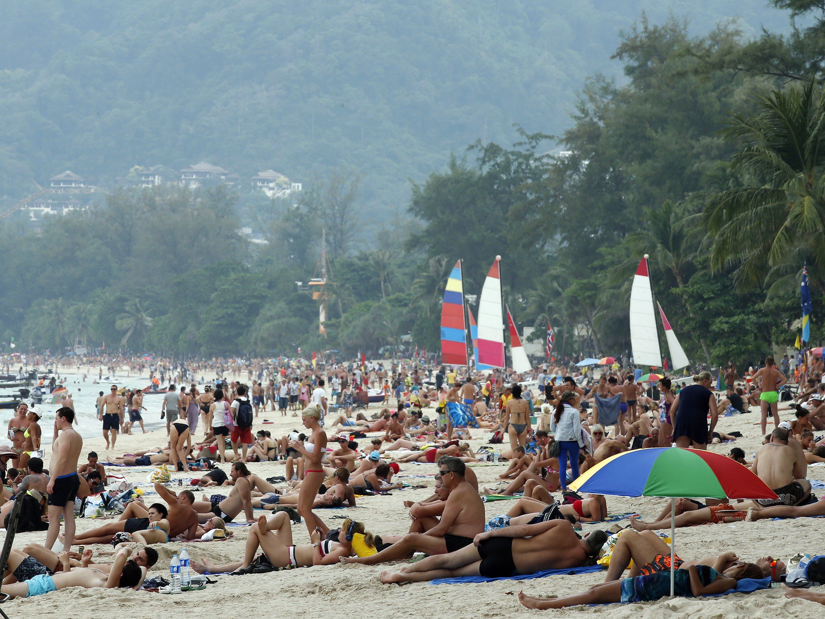 Foreign tourists sunbathe at Patong beach, Phuket island, in southern Thailand. Photo: EPA-EFE