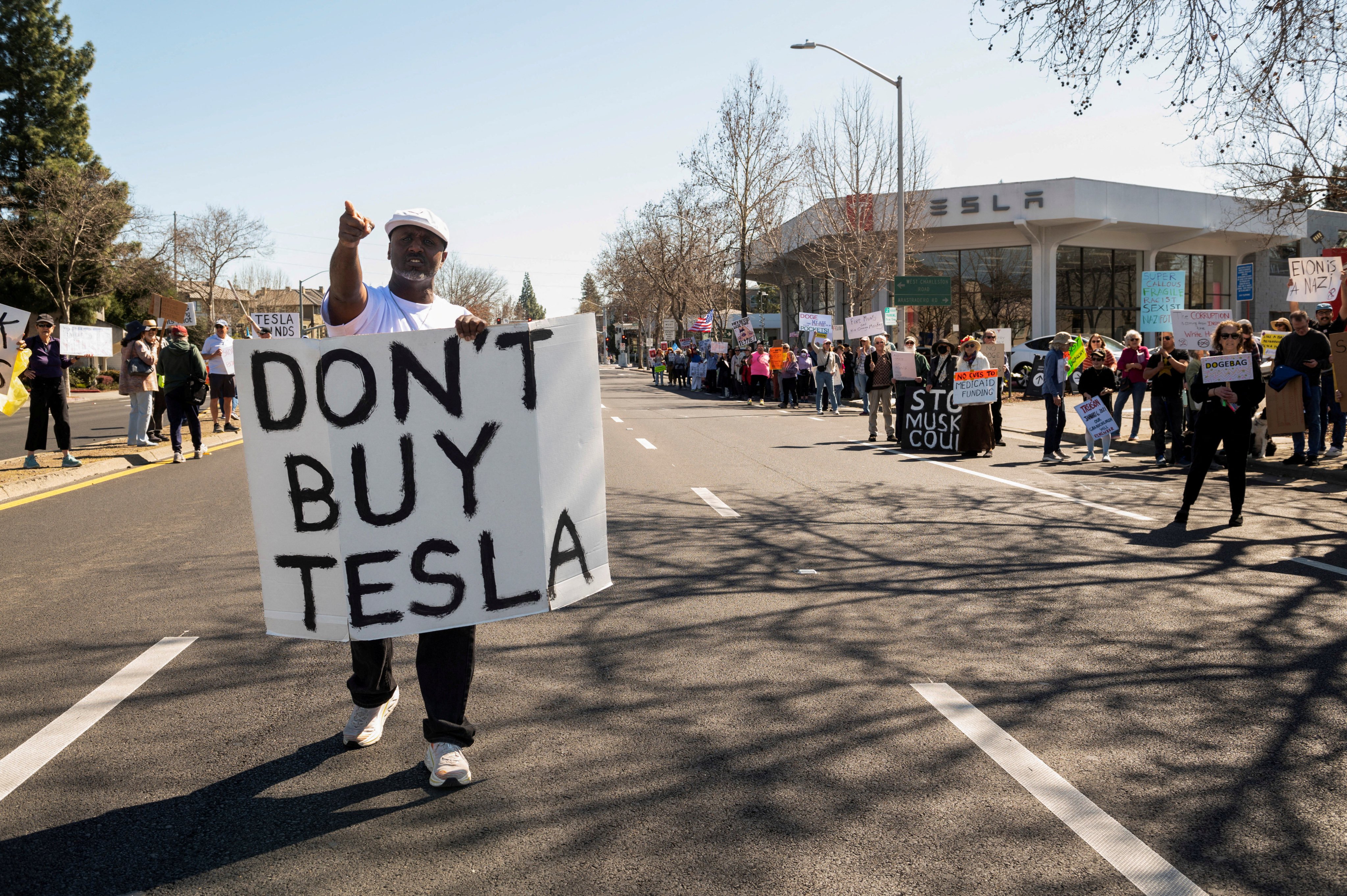 People protest against Tesla and Elon Musk outside a Tesla dealership in Palo Alto, California. Photo: Reuters