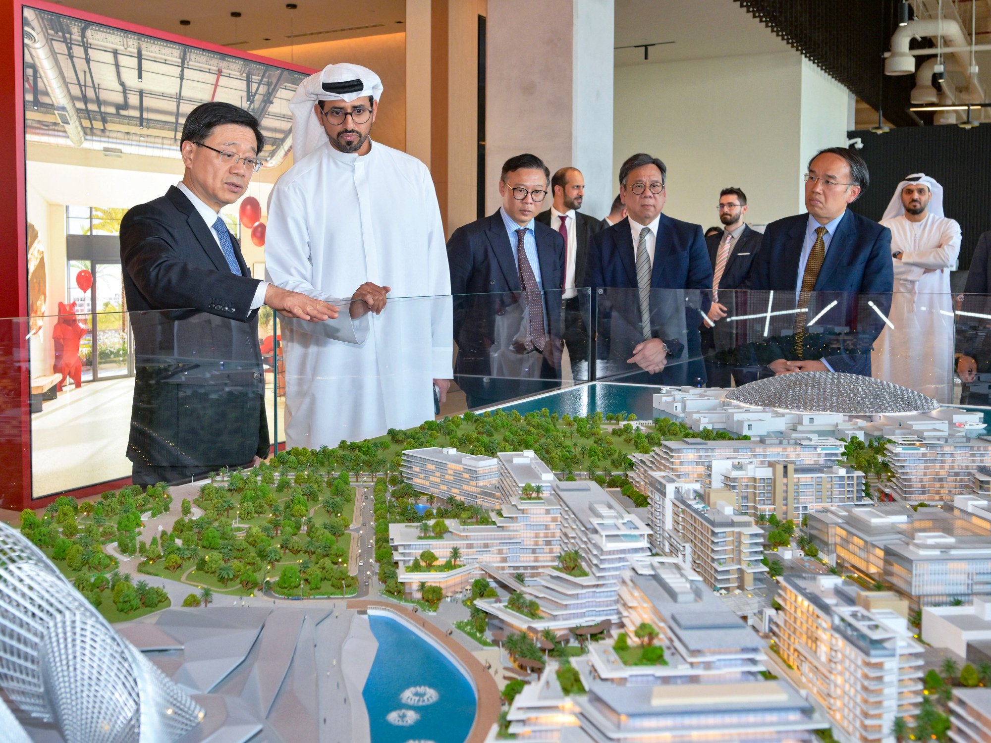 Chief Executive John Lee (left) attends a briefing in Abu Dhabi. He has directed the city to look for new markets in the Middle East. Photo: Xinhua