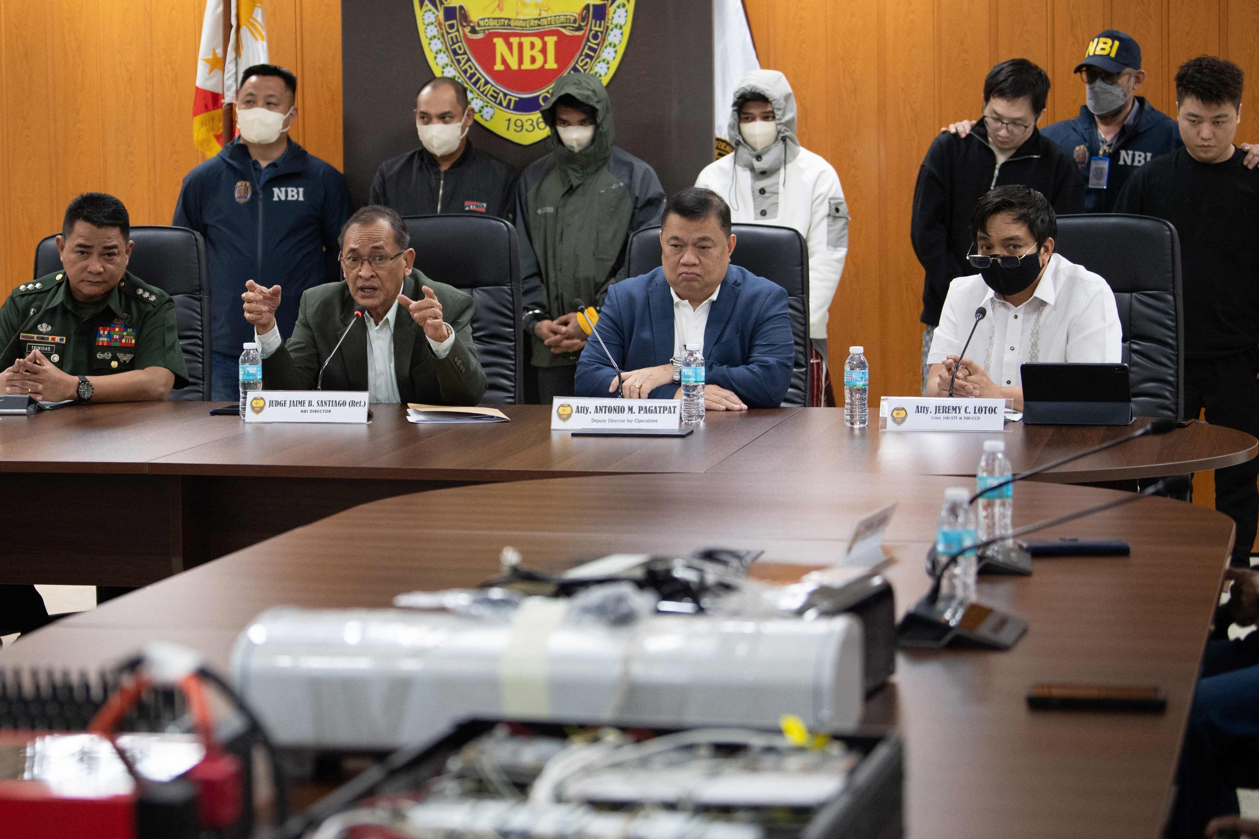 Chinese nationals and their alleged Philippine accomplices, arrested for alleged espionage, are presented during a press conference at the National Bureau of Investigation office in Manila on February 25. Photo: AFP