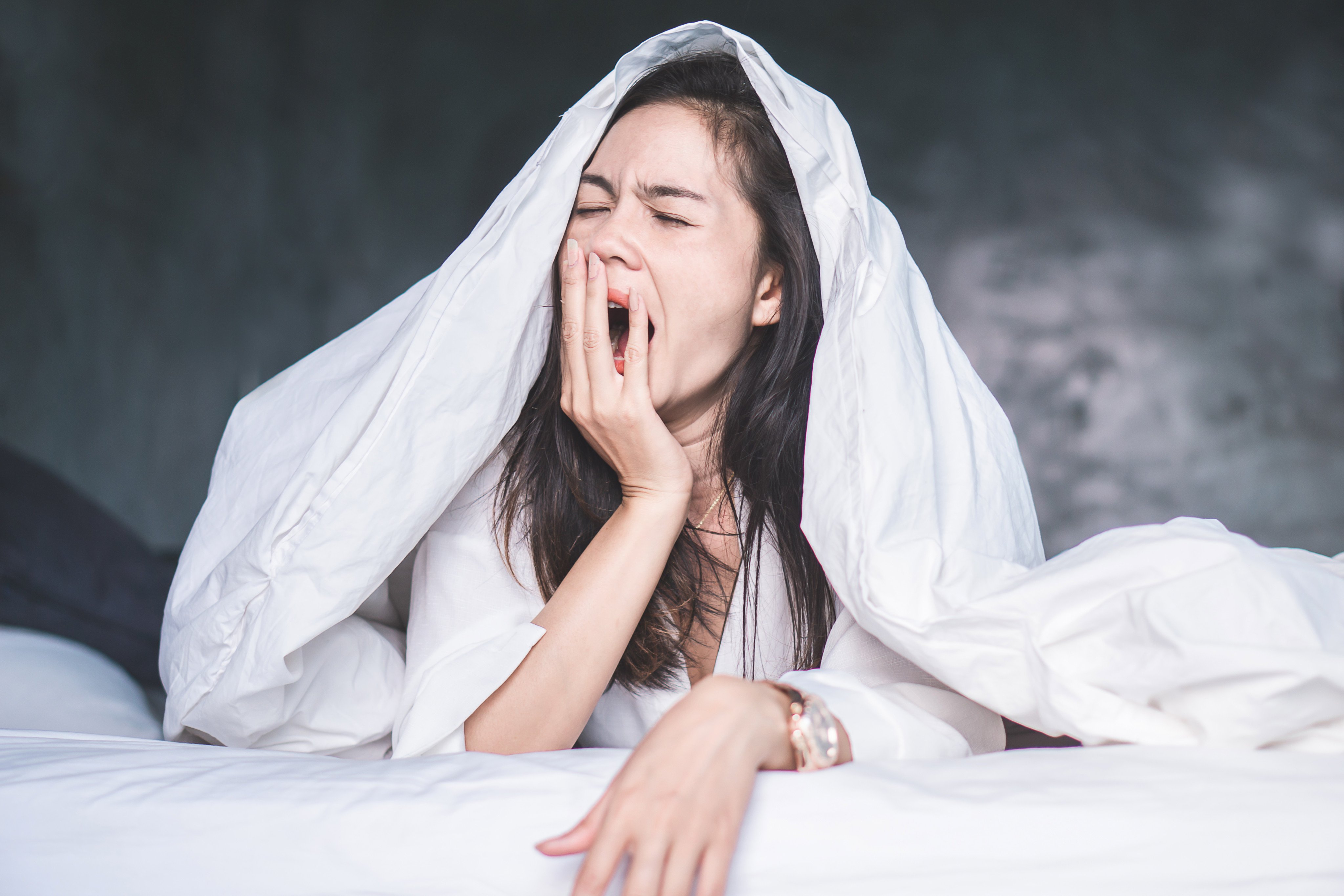 Sleep restriction requires going to bed late, or later than usual, and getting up early. You might begin with just five-and-a-half-hours in bed and work up to six until you’ve found the optimum sleep amount for you. 
Photo: Shutterstock