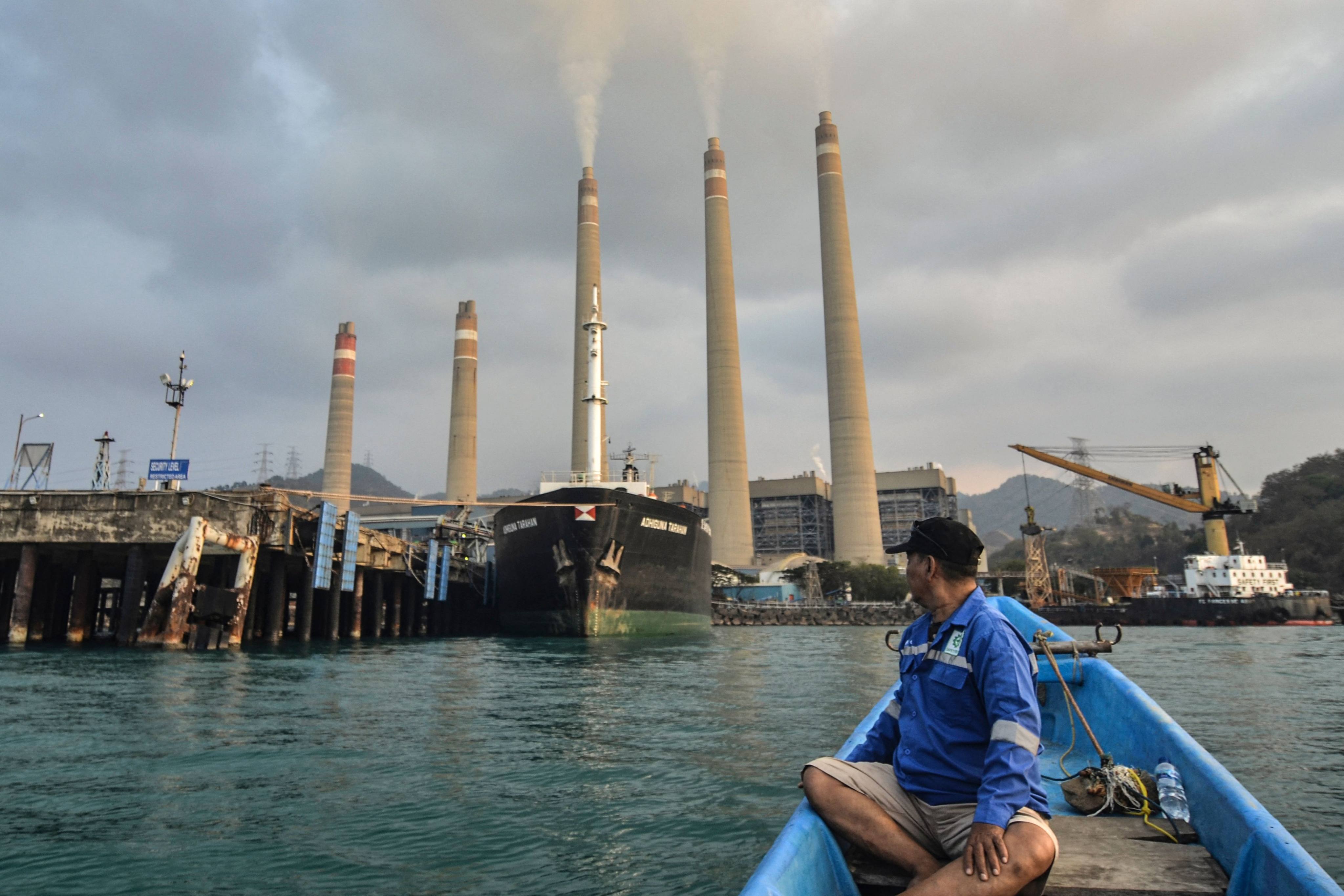 A fisherman looking at the Suralaya coal-fired power plant in Cilegon in Indonesia’s Banten province. Photo: AFP