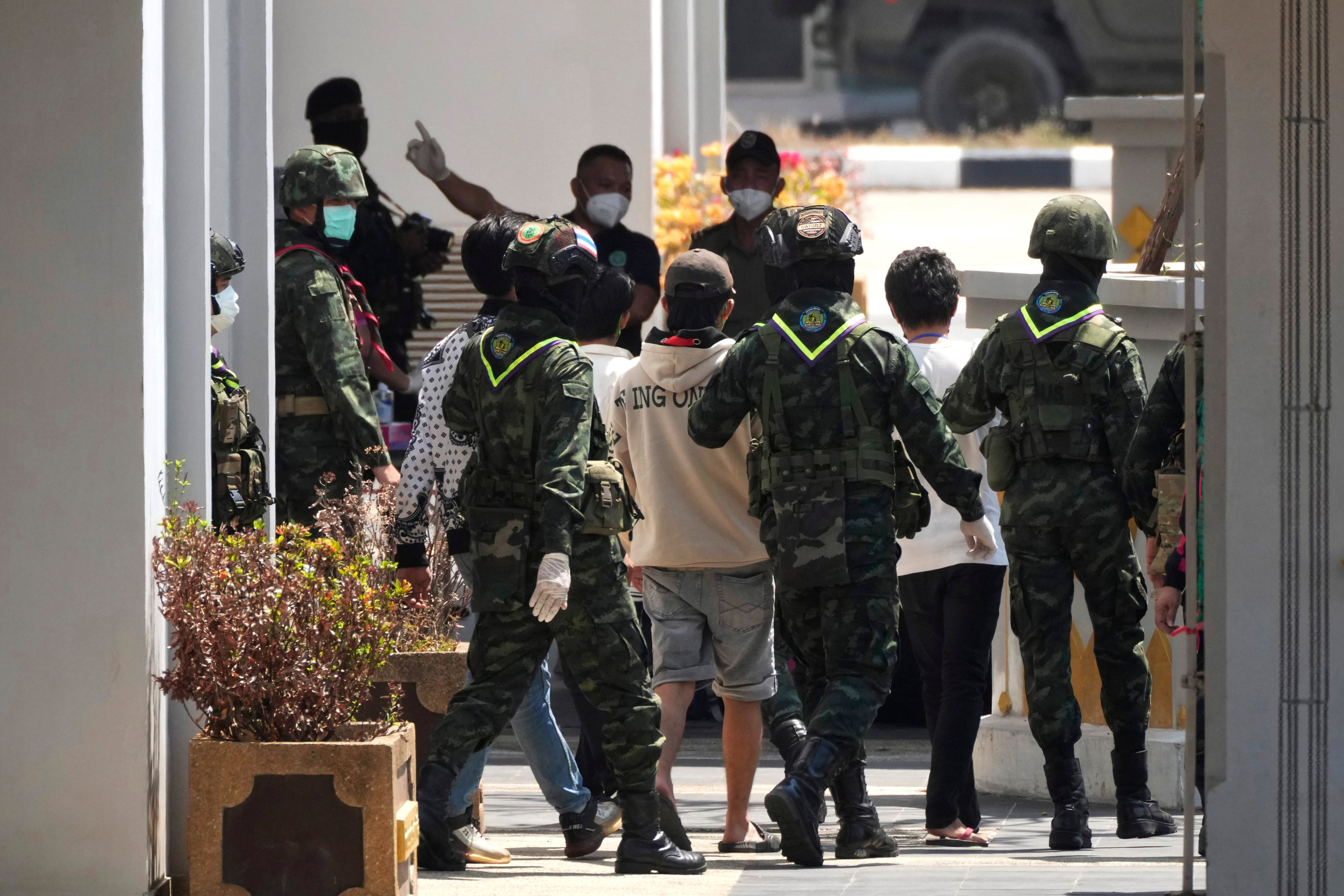 Thai soldiers in Mae Sot provide security for Indonesian nationals who are set to be repatriated after being forced to work at scam centres in eastern Myanmar. Photo: AP