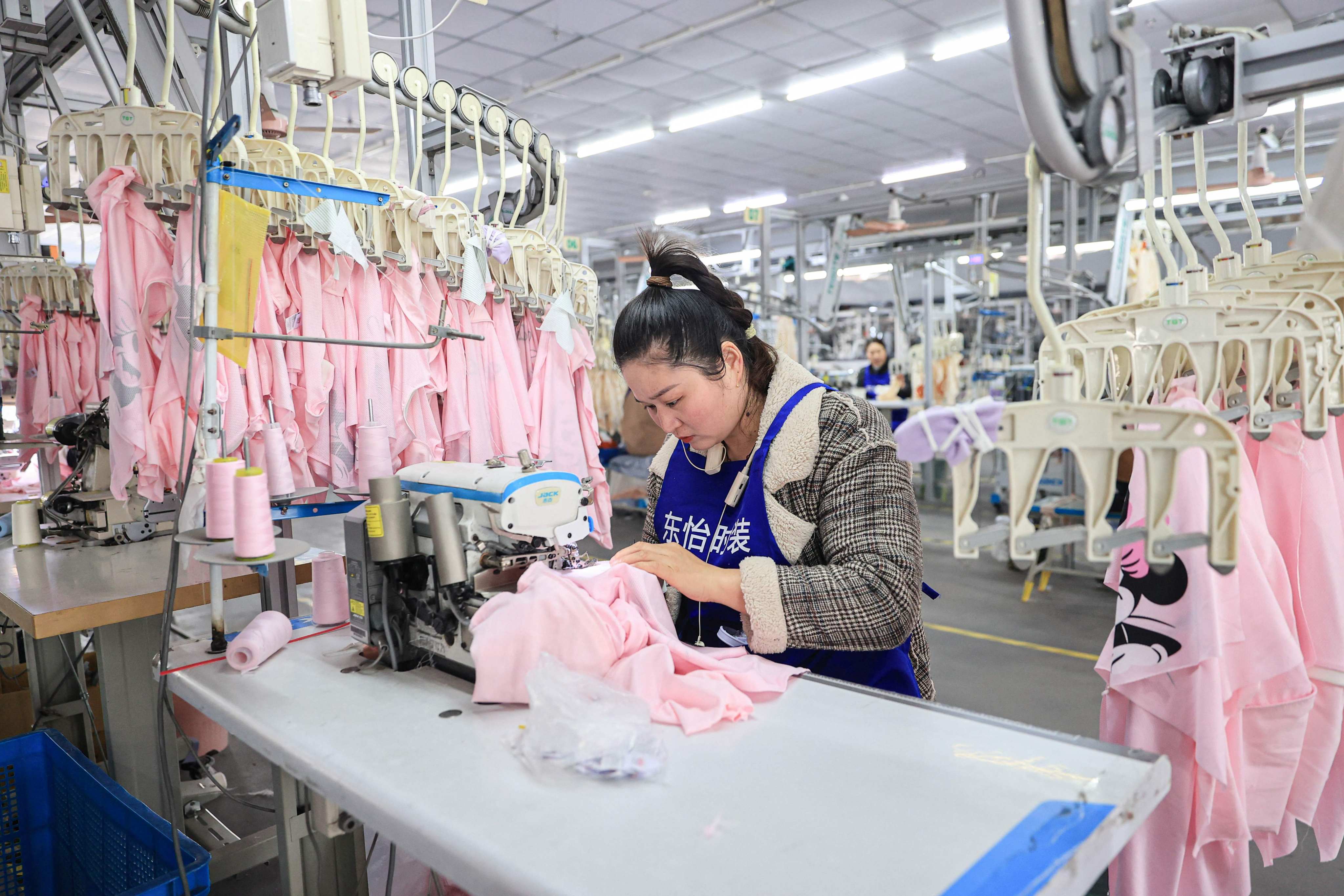 An employee makes clothes at a factory in eastern China’s Jiangsu province. China’s textile and apparel industry is being hit hard by US tariff hikes. Photo: AFP